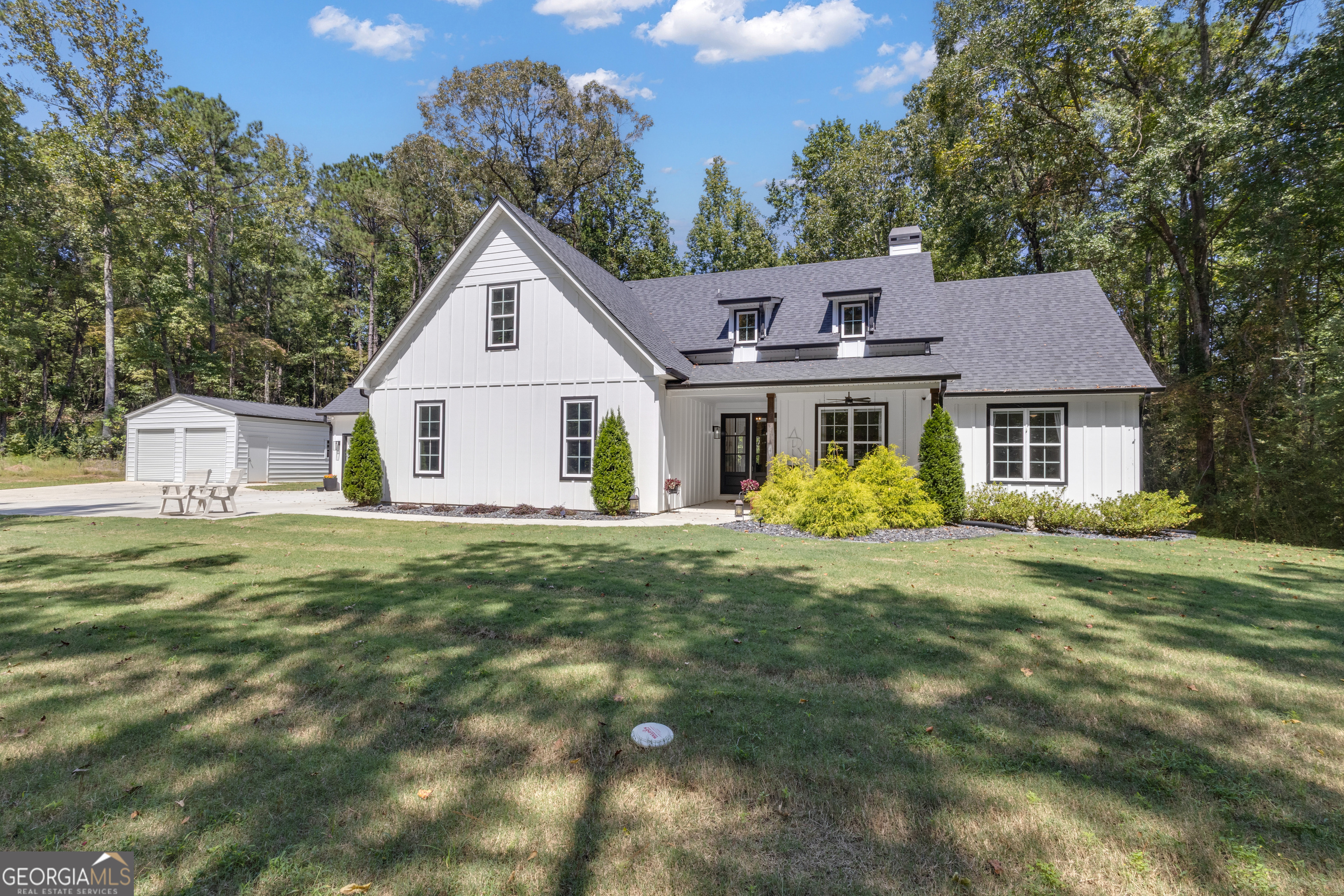 Come home to peace and quiet at this like new story and a half nestled on 5.27 Acres. Split bedroom plan offers many upgrades and high end finishes. Open kitchen with island, overlooks the family room and is adjacent to the formal dining area overlooking the private back yard. Enclosed porch is great for relaxing after a hard days work. Master suite has a dual shower and connects to the laundry room directly via hidden pocket door. Three car garage attached and separate two bay garage/shop highlight this home for all your toys! You only need to make an appointment to view your next home!