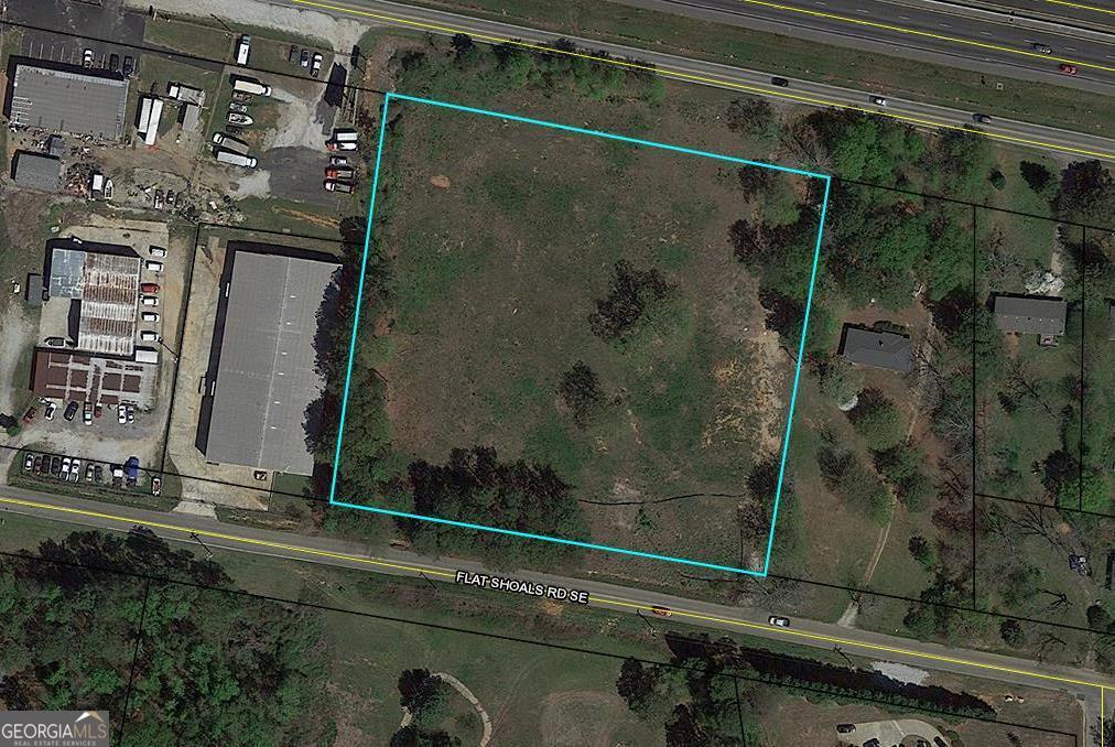 4.3 Acres Commercial Land with double road frontage on Iris Dr which faces I-20 with some interstate visibility and Flat Shoals Rd. A great location of new community growth with supporting dining, shopping and living options. Graded areas for building. Easy access to Salem Rd exit off Interstate 20. This property is Zoned currently CID which would allow for a daycare, preschool, personal care home, banquet hall or events center, fitness, recreation complex and more. Across from a big 300+ home subdivision , it would offer lots of visibility and be super convenient! Call County to ask about possible other uses with perhaps a change application.