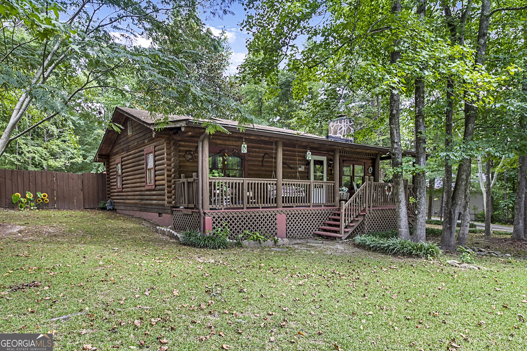 Do you love log homes? Rocking chair front porch? Living in a gated community? Check out this adorable 2BR/1.5 bath log home in Lake Wildwood on a large .74 acre lot with 2 storage buildings in the back yard. Living room features a stone fireplace, LVP floors throughout, country kitchen with pine cabinets and breakfast area. Back room currenty used as dining room with half bath. Washer & dryer stay. Brick patio, gutters, new HVAC & hot water heater. All exterior walls are log - you will love this home!