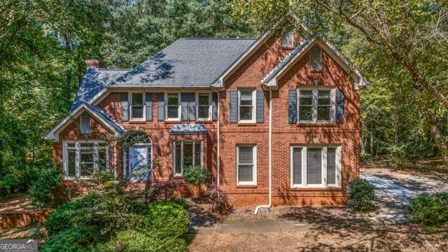 Stunning 4-Sided Brick Home on 2 Private Wooded Acres in Top School District! Surrounded by nature, this beautifully updated residence offers an open, dramatic floor plan featuring two brick fireplaces and gleaming hardwood floors throughout the main level. The chef's kitchen boasts stainless steel appliances, granite countertops, and a travertine backsplash. A guest suite/office on the main level provides flexibility, while recent updates include a newer roof, carpet, and a brand-new poured driveway. The luxurious owner's retreat showcases a spa-inspired bath with a real marble vanity, frameless glass shower, and elegant cut-glass tile accents. All baths have been remodeled with stylish furniture-style vanities. The finished terrace level offers additional living and entertaining space. This home is move-in ready.