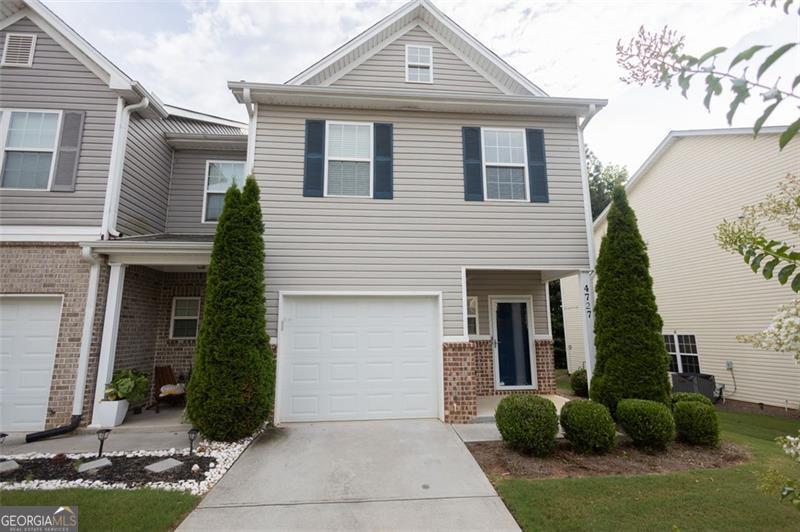 Welcome Home! This stunning 3-bedroom, 3-bathroom townhome offers the perfect blend of comfort, style, and convenience. Step inside to find durable and beautiful LVP throughout the lower level, a dedicated dining room perfect for entertaining, and a modern kitchen featuring granite countertops, rich espresso cabinets, and stainless steel appliances. Upstairs, enjoy plush carpeting in all three bedrooms, including a spacious primary suite with a walk-in closet and a private en-suite bath. A full laundry room adds everyday ease, while thoughtful layout ensures privacy and functionality. Relax outdoors on your private patio that backs up to a peaceful wooded area-ideal for morning coffee or evening unwinding. An attached garage provides added convenience and storage. Located in a desirable community with access to a sparkling pool and fun-filled playground, this home checks every box for comfort and lifestyle. Don't miss your chance to make it yours!