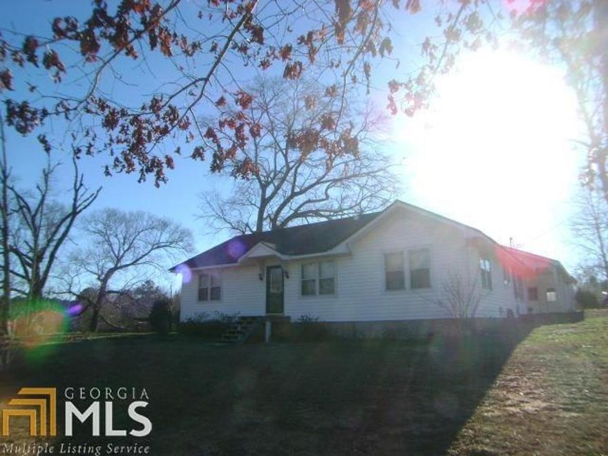 Country living with this ranch home on 3 acres of land. Great Room, separate dining room or den, Country kitchen with breakfast room and breakfast bar. Three bedrooms, 2 full baths. Double attached carport and a oversized one bay garage with extra bay for storage.