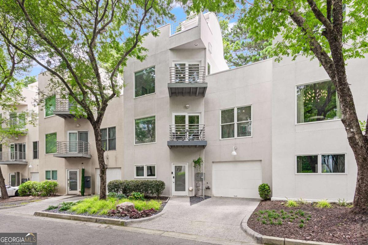 Welcome to 2180 Millennium Way, a stunning 3-story townhome designed by renowned Atlanta architect Franz Schneider. Tucked inside a quiet, gated community, this residence blends modern elegance with comfort and features a unique open-loft style floor plan in the heart of Brookhaven.    Step inside and enjoy abundant natural light, soaring ceilings, and a layout perfect for entertaining. The terrace-level bedroom with en-suite bath is ideal for guests or a home office, while the oversized primary suite spans the entire third floor with a large walk-in closet and serene treetop views. This home includes multiple upgrades including newer appliances, remote-controlled blinds on the main level, a tankless hot water heater, and a new HVAC (2024).    Three private decks offer ideal outdoor living, and the oversized 1-car garage includes extra storage or home gym potential.    Located just minutes from I-85 and North Druid Hills, you're within walking distance to the newly renovated Brookhaven Park with swim, tennis, trails, and community events-plus all the shops and restaurants of Brookhaven Village.    This stylish home delivers the best of location, design, and lifestyle!