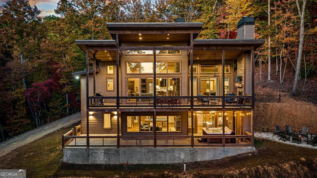 Charming, modern chalet with seasonal mountain view, luxury features, and exceptional rental history offered fully furnished and turnkey. Just minutes from Blue Ridge, this 3-bedroom chalet offers 2 full-size bathrooms, 1 half bath, and room for 10 guests. Luxury tiled baths, high end Italian appliances, multiple indoor and outdoor fireplace, 7-person hot tub...the features go on and on! Gross for 2023 was $113k. This property would make a great investment cabin or luxury vacation home.