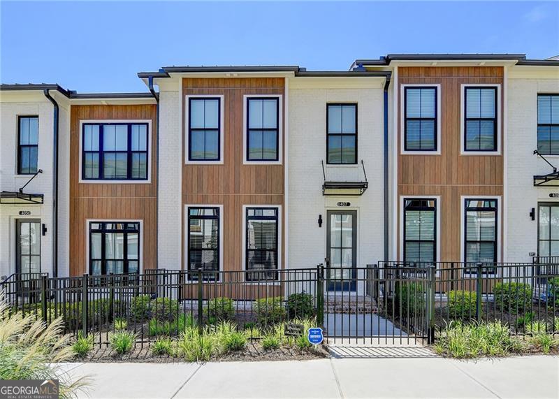 EAST-FACING & MOVE-IN READY! Immaculate, sunlit townhome in prime Alpharetta location! Popular sold-out floor plan features 3 spacious bedrooms, 3.5 baths, and a versatile layout across 3 levels. Gourmet kitchen boasts quartz countertops, GE SS appliances, soft-close cabinets, under-cabinet lighting & walk-in pantry. Sunroom off kitchen makes a perfect office or dining space w/access to deck. Spacious family room and open dining area ideal for entertaining. Upstairs features oversized owner's suite w/tray ceilings, walk-in closet & spa-like bath. Terrace-level guest suite w/full bath & walk-in closet. 2-car garage + 2-car driveway. Ample guest parking. Incredible location-moments to Avalon, Downtown Alpharetta, Alpha Loop, Big Creek Greenway & future North Point redevelopment. OWNER RELOCATING-DON'T MISS THIS RARE OPPORTUNITY!