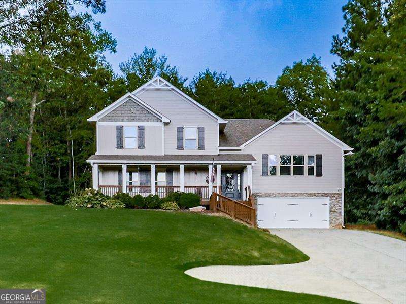 Welcome Home to Space, Style, and Serenity! Tucked into a well-established community known for its oversized lots, top-rated schools, and fantastic location, this impeccably maintained home offers the perfect mix of charm, upgrades, and flexibility! Start your day on the expansive front porch, the perfect spot to sip your morning coffee and enjoy the peaceful setting. Step inside to a light-filled home that is perfectly maintained with tons of updates...better than new! Love to cook or entertain? The spacious kitchen is a dream, showcasing white cabinetry, sleek marble countertops, stainless steel appliances, a large island, and a massive breakfast room that easily fits a crowd. A soaring vaulted family room adds even more living space, complete with a cozy fireplace and an abundance of natural light. Upstairs, the oversized owner's suite offers a private escape with a walk-in closet, dual vanities, a soaking tub, and separate shower. Secondary bedrooms are spacious and share a beautifully updated full bathroom. Thoughtful updates include new interior paint, new flooring, modern lighting, a new front door, landscape lighting, and more-this home is spotless and move-in ready. The lower level offers so much potential, ideal for an in-law suite, teen hangout, or home office. Step outside to a private yard-plenty of space to play, garden, or unwind. The extended driveway provides tons of extra parking for guests, RVs, or trailers. ?? All of this in a location that's hard to beat-minutes from shopping, dining, parks, and award-winning schools. ? A beautiful home. A fantastic lot. And a lifestyle you'll love.