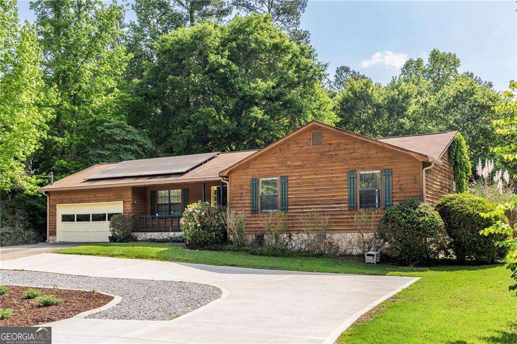 ENJOY A COMPLETELY PAID OFF SOLAR PANEL SYSTEM WITH BATTERY BACK UP! Great opportunity to have OPTIONAL lake living in this picturesque Swan Lake community! This home is a part of an optional HOA that allows access to the lake for boating and fishing or you can opt out completely from the HOA and simply enjoy your own backyard oasis! The home features a large screened-in porch over looking your serene, private, level backyard plus an above ground pool that is great for cooling off in the GA heat! Backyard also includes a pool deck and a heated workshop that is perfect for any hobbies or can be used as additional storage. A large, circular driveway in the front of the home is perfect for an RV or tons of extra parking! As you enter the home you are greeted by an oversized living room. French doors off the living room take you to either a formal dining room or an office. The kitchen features stainless steel appliances and a space for a breakfast table. Off the kitchen is a laundry room and large 2 car garage. Down the hall you will find the primary bedroom with a walk-in closet and en-suite, plus two secondary bedrooms and a full guest bath. The best part of this house is that it is energy efficient! Home is equipped with solar to help reduce energy costs and includes a convenient battery backup to keep comfortable during any storms! This property has the best of both worlds, a peaceful setting yet conveniently located under 30 minutes to Hartsfield Jackson Atlanta International Airport!