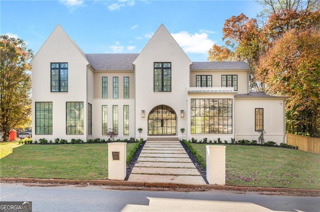 Nestled on a sprawling corner lot in the prestigious Brittany neighborhood, this 5-bedroom, 5-bath estate with a powder room, sparkling pool, and UNFINISHED basement redefines luxury living. The home features extraordinary lighting by Visual Comfort, cedar garage doors, gas lanterns, a curved oversized iron door, and custom designer cabinetry. With a 3-car garage and meticulously crafted spaces, every detail has been thoughtfully curated to elevate your lifestyle. Step inside through the elegant archway into a home that exudes sophistication, complete with a private study, formal dining room, and a well-appointed mudroom. The gourmet kitchen, with high-end finishes, a catering pantry, and a bright breakfast area, overlooks the family room. The family room is highlighted by a striking fireplace, creating a warm and inviting space for gatherings. The main-level primary suite serves as a serene retreat, offering dual walk-in closets and a spa-inspired bath with a freestanding tub and separate shower. Upstairs, four guest suites-each with a walk-in closet and private bath-ensure space and comfort. The second floor also features a spacious loft and a conveniently located laundry room. The outdoor living space is an entertainer's dream, with a covered lounge featuring a fireplace, a full outdoor kitchen, and the pool with a walkout backyard. A separate entry adds convenience for guests. Ideally located in Brookhaven, this exceptional home offers easy access to premier shopping and dining, making it the perfect blend of elegance and lifestyle.