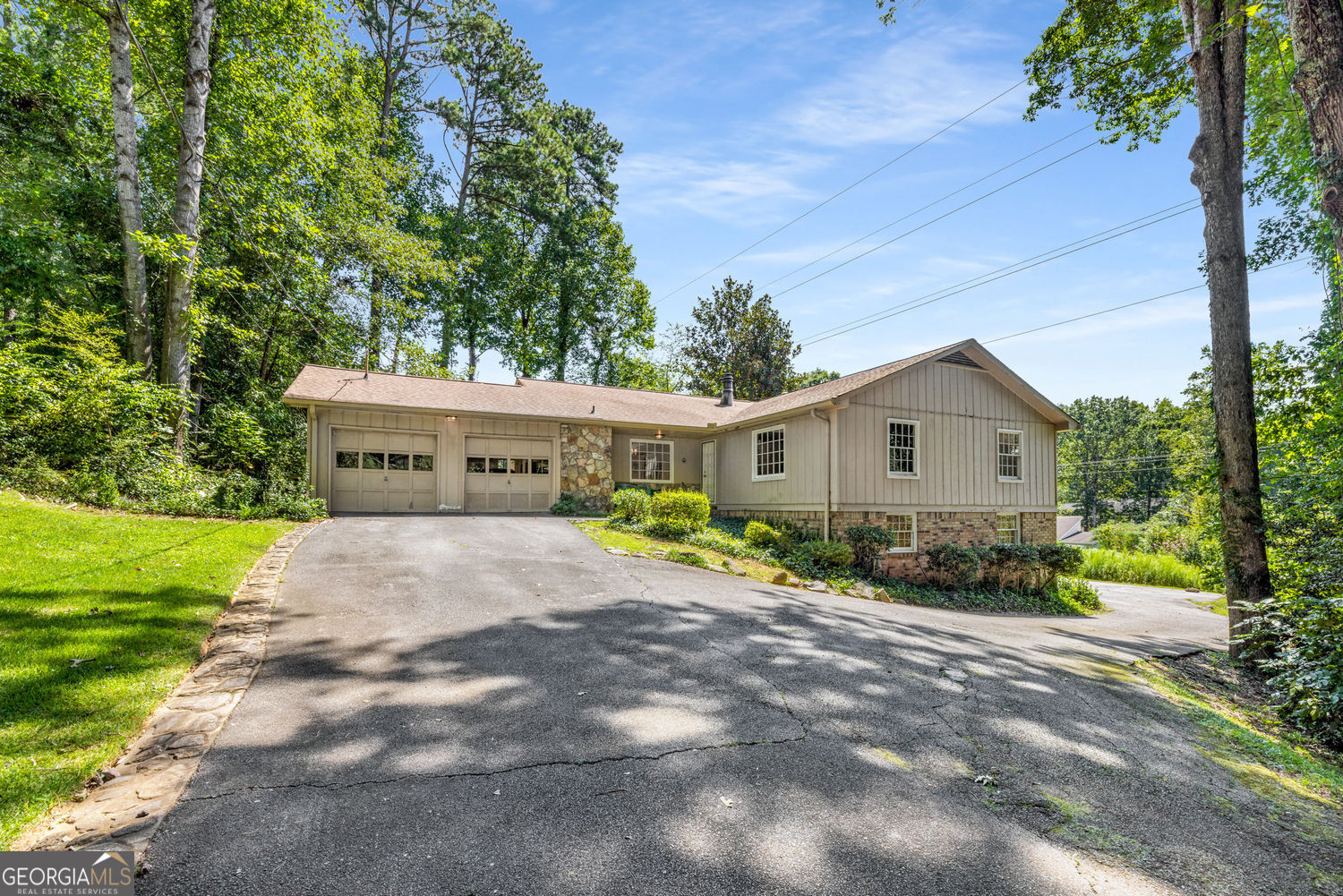 Located in one of the area's most sought-after school districts-Sope Creek Elementary, Dickerson Middle, and Walton High School-this 1971 ranch presents endless possibilities. This home has strong bones but is in original condition and ready for your special touches. With 4 bedrooms and 3 full baths, including a fully finished terrace level with a second kitchen, this charming home has plenty of space and sits on just shy of an acre. Situated on a quiet cul-de-sac, there's also a 32' by 45' parking pad behind the house, perfect for an RV, boat, or even a sport court! Whether you're a buyer looking to create your dream home in a premier location, or an investor seeking a high-potential project, this home is the perfect canvas. Opportunities like this in such a desirable district are rare-don't miss your chance to make this one your own!