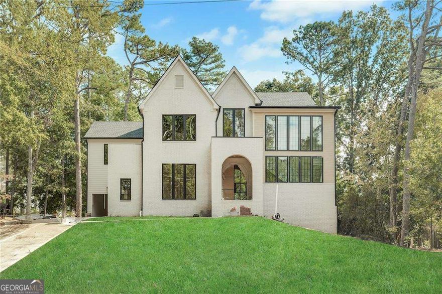 Come see this inviting new construction home nestled in a prime Sandy Springs location, offering the perfect blend of elegance, comfort, and modern living. Step through the portico arch entry into a grand foyer with soaring 10-foot ceilings and stunning hardwood floors that flow throughout the home. The main level features a guest suite with a full bath, a separate dining room with vaulted ceilings-ideal for entertaining. The heart of the home is the designer kitchen, complete with top-of-the-line appliances, custom cabinetry, and a spacious scullery, all overlooking the family room and a cozy fireplace. A mudroom off the kitchen adds convenience, while thoughtful design elements create a seamless flow for everyday living. Upstairs boasts vaulted bedrooms, and a luxurious primary suite with a spa-like bath featuring custom walnut double vanities, a soaking tub, separate shower, and large walk-in closet. The upper level also includes three additional ensuite bedrooms and a convenient laundry room, providing space and functionality for family and guests. Enjoy outdoor living at its finest with a covered porch featuring a fireplace overlooking a private backyard with plenty of room for a POOL. This 5-bedroom, 5.5-bath home also includes a 3-car garage and an UNFINISHED basement-offering endless potential for customization to suit your lifestyle. Perfectly situated in the heart of Sandy Springs, this home combines the tranquility of a private setting with the excitement of nearby premier shopping, dining, and entertainment. Every detail has been thoughtfully designed to offer both comfort and sophistication in one exceptional home.