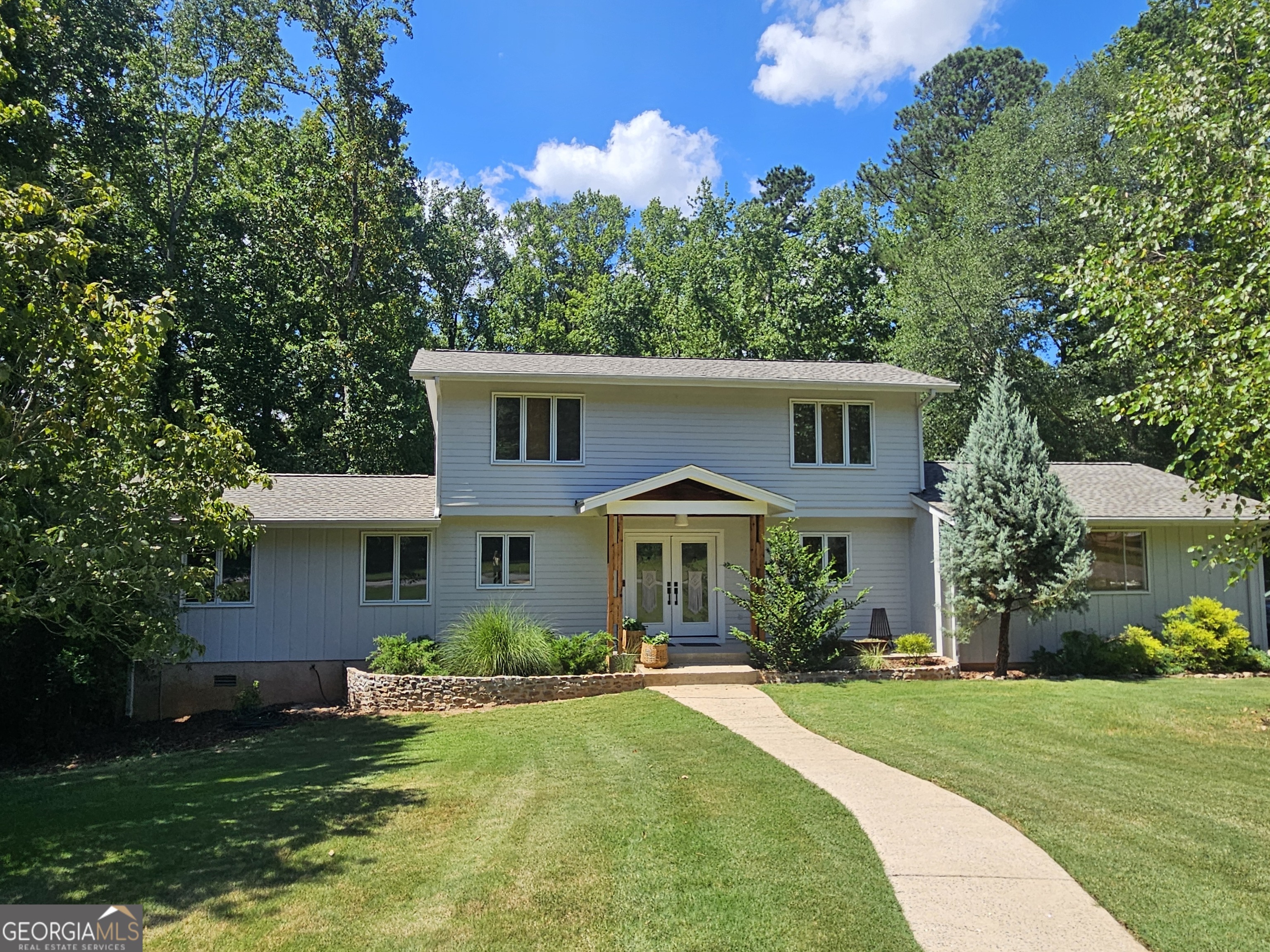 Drop dead gorgeous!!! Meticulously maintained west side charmer with a mid century flair and a fabulously unique floor plan, this easy living home invites gathering of family and friends, perfect for entertaining large or small, and adding in summertime pool fun, this home has it all! Year round enjoyment for bocce ball in the huge yard while grilling by the pool, peaceful porch retreat time for coffee in the morning and quiet fireplace evenings or merry holiday cheering. Two large living areas offer ample comfort and flexibility for entertaining along with a lovely screened in back porch which is its own paradise for parties or sitting and watching the deer roam through the yard. A full complete kitchen at terrace level and an EcoSmarte System in-ground pool round out this perfect arrangement for ultimate relaxation and hosting. Expansive owner's suite on the main level is a true oasis and also offers private stairs down to the pool. All bedrooms are extremely large, and the flex office space downstairs has served as a bedroom when needed with adjacent full bath. Terrace level can function as a true in law suite or mini apartment for guests, family and friends. So many extras!! Brand new roof May 2025, new great room interior paint May 2025, complete exterior paint 2022, kitchen remodel 2021 with new dolomite countertops, gas range, new cabinets and stainless appliances. Terrace level renovation 2020 with full kitchen and bath and flex/office space. Owner's bath gorgeous tiled shower 2020. Cedar front porch, custom corten steel mailbox with cedar post, newer front door, whole house Ring Security System, HVAC 2018, new french drain/sump pump/vapor barrier 2018, Pella windows, gorgeous original doors throughout, ceiling fans throughout, EcoSmarte Pool System for chlorine and salt free swimming, custom pool cover. Private backyard with native wood border and creek at back of almost an acre of carefree living. Baby grand piano can convey with property if desired. One of the most unique homes in Athens in one of the most desirable in-town yet quiet neighborhoods, this beauty is ready for a new chapter! Walking distance to shopping, eating and Timothy Elementary. GREAT neighbors! Kingswood is all about it with lots of neighborhood events annually, a community green space and lots of walking trails by McNutt's Creek, just for Kingswoodians! UGA and downtown just a short 8 min. drive away!