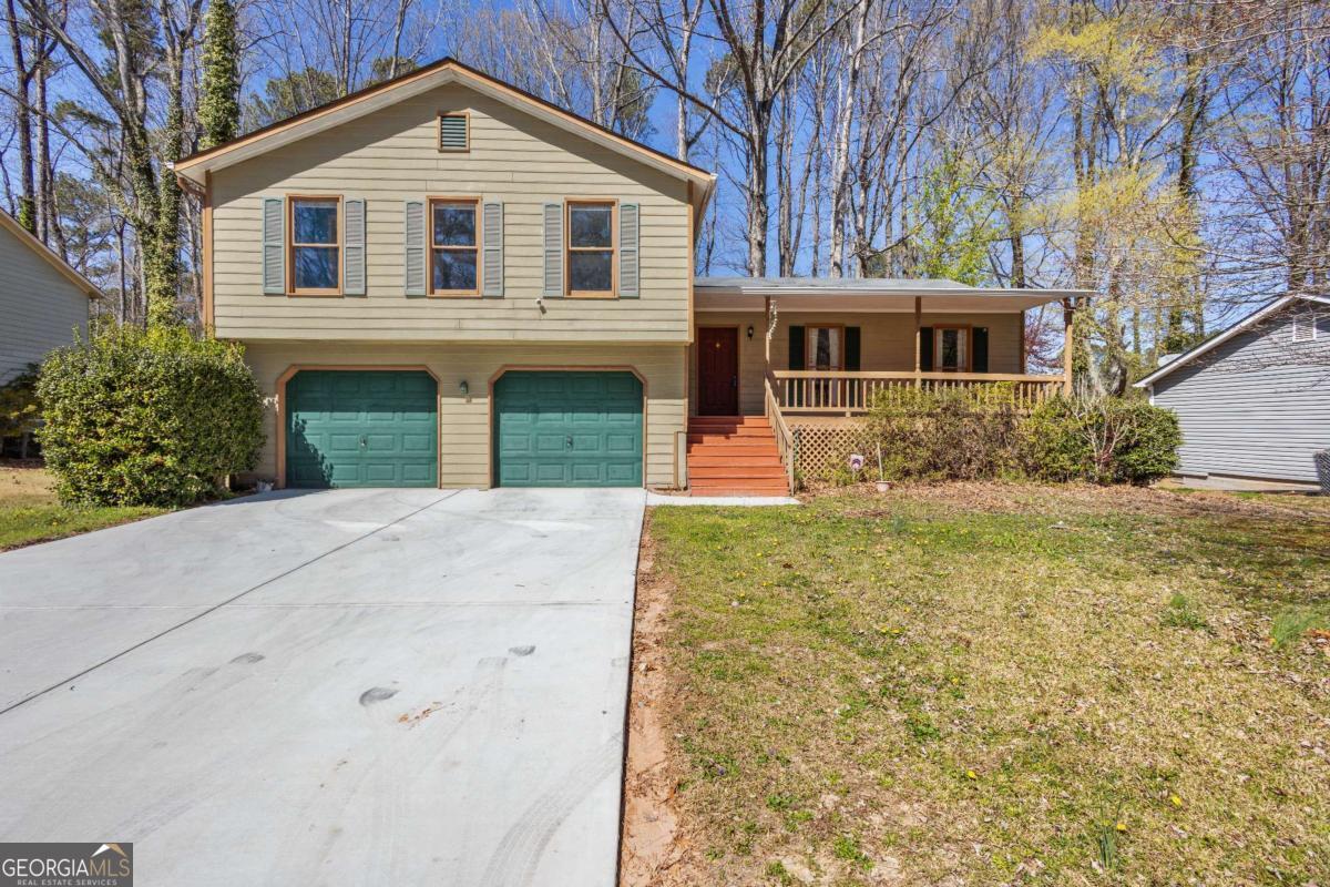 Ideally located near historic Marietta Square, this well-kept split-level home offers generous living spaces and timeless comfort. Enjoy a bright formal living room, separate dining room, and a spacious eat-in kitchen designed for functional everyday living. The lower-level family room features a natural stone fireplace and adjacent half bathCoperfect as a cozy retreat, entertainment space, or optional fourth bedroom. The primary suite on the main level includes a double vanity, whirlpool tub, and separate shower. Relax or entertain on the extended deck overlooking a private, wooded lot. A two-car garage, level driveway, and peaceful community setting complete the package. A fantastic opportunity in a prime locationCoschedule your showing today!