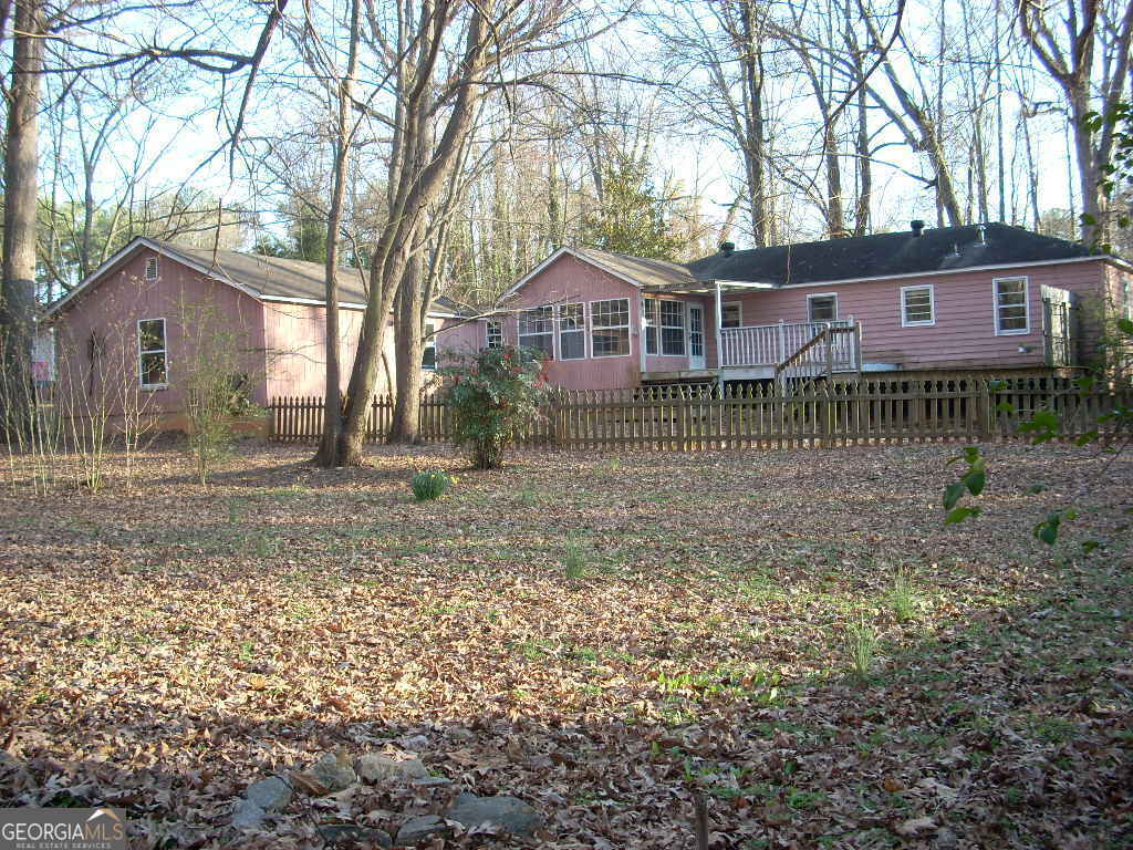 Put your renovating skills to work at this private, vacant single story ranch on a large 0.4 acre lot at end of dead end street skirting Mableton Elem. The 14'x27' master suite addition and a separate 24'x32' 4 car garage/shop built circa 2004 has been heavily damaged by a tree fall. Tree has been removed, most of the flattened garage has been hauled away along with much of the addition's debris. Now it's your turn to make it beautiful and profit. The HVAC is 4y old. Tankless water heater, 3y. Roof is 2 y old. Power entry/breaker panel box is up to code(pic.). Garage can become an ADU. Home is sold as is, likely not FHA eligible. Seller requests due diligence be completed prior to submitting an offer. This home needs a full renovation. The seller will not make any repairs. Seller has neverlived in the house. Buyer to verify all info deemed important prior to purchase. Some pictures are not current and have been included to indicate the inviting character of the home, See the potential.