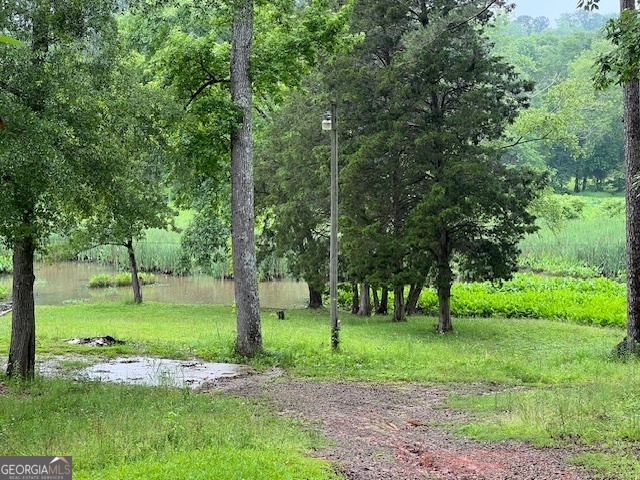 This is a nice 1.5 acre building lot which is actually 2 lots. The property does have water frontage but is not boatable. Would make great fishing are and easy access to good Lake water as well. There is already a well septic tank and electricity at the property.