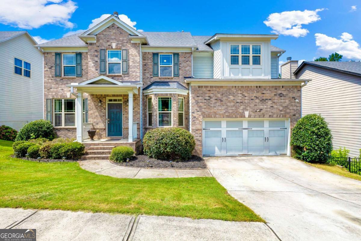 Beautiful brick-front 5-bedroom, 4-bath home in the sought-after Primrose Creek swim/tennis community! Step into a welcoming foyer with formal dining and a versatile study/living room. The kitchen boasts stainless steel appliances, wood cabinetry, granite countertops, and a walk-in pantry. The kitchen opens seamlessly to the breakfast area and spacious family room, featuring a cozy fireplace and a wall of windows filling the space with natural light. The main level also includes a convenient guest suite with a full bath. Upstairs, the oversized master retreat offers a tray ceiling, spa-like bath with his/her vanities, soaking tub, separate shower, and a huge walk-in closet. Three additional large bedrooms, two full baths, and a generous media/loft space complete the upper level. The home also features a full unfinished basement offering endless possibilities for storage, recreation, or future expansion. Enjoy outdoor living with double decks and a large, private fenced backyard perfect for entertaining. This home is ideally located in a top-rated school district, within walking distance to elementary and middle schools, just 3 miles from Lake Lanier's fishing inlets, and minutes from the growing dining and shopping scene in Downtown Sugar Hill. The perfect house, convenient location, and a private oasis all in one!