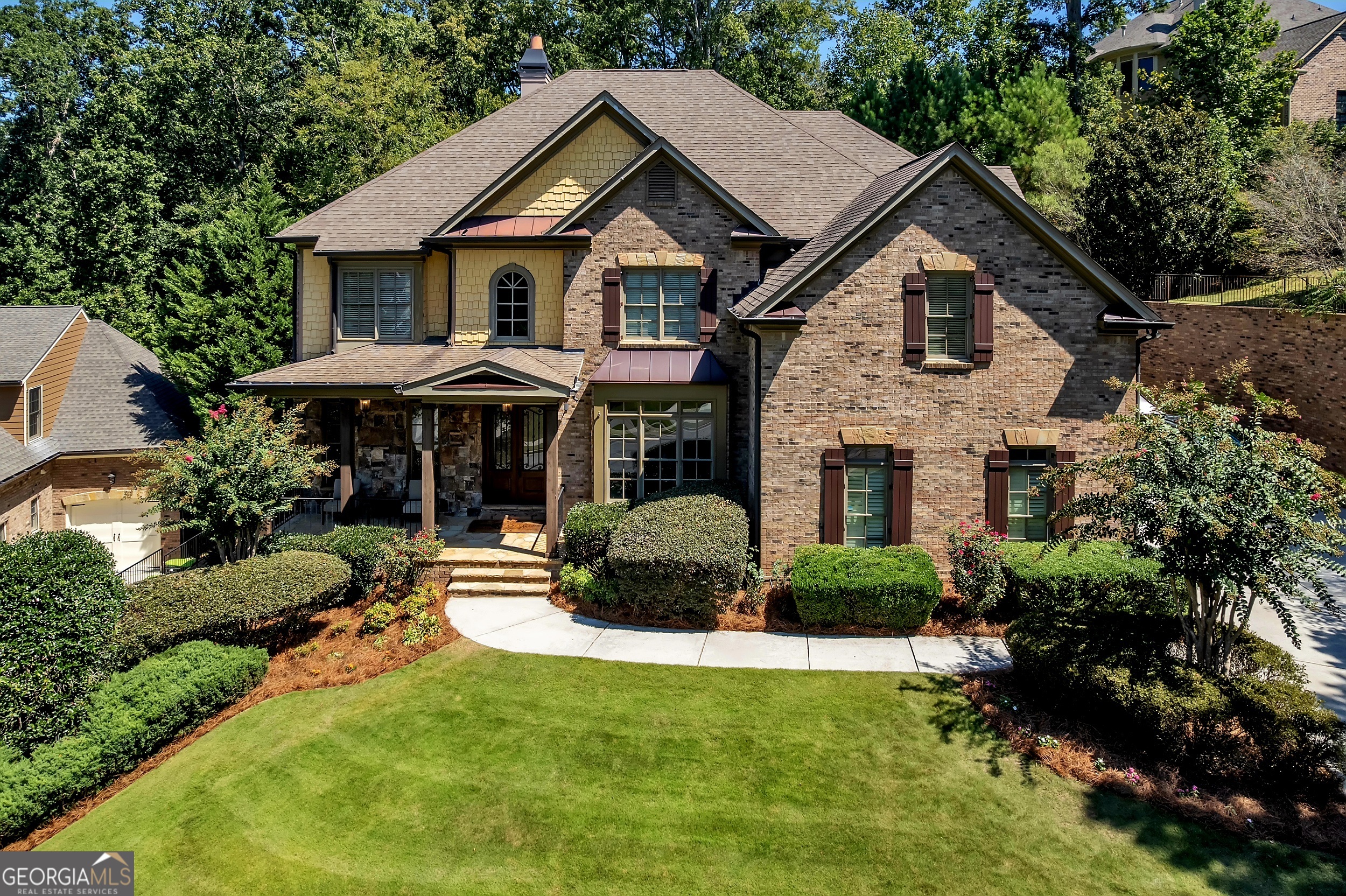 Formerly featured on HGTV, this extraordinary estate at 5709 Registry Oaks Lane is a masterful blend of designer luxury and inviting comfort. It's more than just a house; it's a showpiece where every detail has been thoughtfully curated to create an unparalleled living experience. Step inside and be captivated by the two-story foyer, where a glamorous designer chandelier casts a warm, welcoming glow. The grand entrance sets the tone for the entire home, leading you into a dramatic open floor plan with soaring ceilings and rich espresso hardwood floors. Exquisite custom details, including ten-inch baseboards, ornate crown molding, and sculpted door casings, flow seamlessly throughout the home, creating a sense of timeless elegance. Custom lighting fixtures, from sleek pendants to elegant chandeliers, have been meticulously selected to enhance every space. In the heart of the home is an expansive great room, with its 14-foot coffered ceilings and a breathtaking custom-cast stone fireplace that invites you to relax and unwind. The dining room, with its stunning wall of windows, is bathed in natural light, offering the perfect setting for both large-scale celebrations and quiet family dinners. A true culinary dream, the gourmet chef's kitchen features stunning Calcutta gold marble countertops, top-of-the-line appliances, and a massive central island-the perfect stage for both lively entertaining and cozy gatherings. The kitchen flows seamlessly into a comfortable keeping room, ensuring you're always connected to the conversation. The primary suite is a sanctuary of indulgence. It features a private sitting room with its own fireplace and an incredible custom closet designed to be a "California dream." The spa-inspired ensuite bath offers a serene escape, complete with an oversized premium tiled shower, promising relaxation at the end of a long day. In the study, custom built-in shelving provides both function and beauty, adding to the home's bespoke feel. This true 5-bedroom, 4-bath home offers endless possibilities for entertainment and recreation. The finished terrace level is a true haven, complete with a private movie theater, a dedicated exercise room, and a stylish wet bar. An added bedroom and full bathroom on this level provide the ultimate flexibility for guests. Upstairs, an elevated den and media room offer a perfect vantage point to take in the breathtaking views of the private, fully fenced backyard. Outdoors, your private oasis awaits. The meticulously maintained, lush green lawn provides a stunning backdrop for the built-in firepit, a charming HGTV-featured "she-shed," and a play area, all maintained by an automatic irrigation system. It's a perfect setting for al fresco dining, lively gatherings, or a quiet evening under the stars. The home also features a three-car garage with a charging station, offering ample space for vehicles and storage. Situated in a prime Mableton location, this home offers the best of both worlds: a secluded retreat with unparalleled convenience. It is just minutes from top-rated private schools like Whitfield Academy and SAE School, and offers easy access to the area's best shopping, dining, and parks. With downtown Atlanta just a short drive away, and Hartsfield-Jackson Airport roughly 20 minutes from your door, you're connected to everything you need while enjoying the privacy and tranquility of your own estate. This is your chance to own a home with genuine star power-a property that perfectly balances sophisticated design with the warmth of a family home. Don't miss the opportunity to live your dream. For more information call Patrick Walters 678-939-1941, ALICE OMOROGBE 404-375-7313