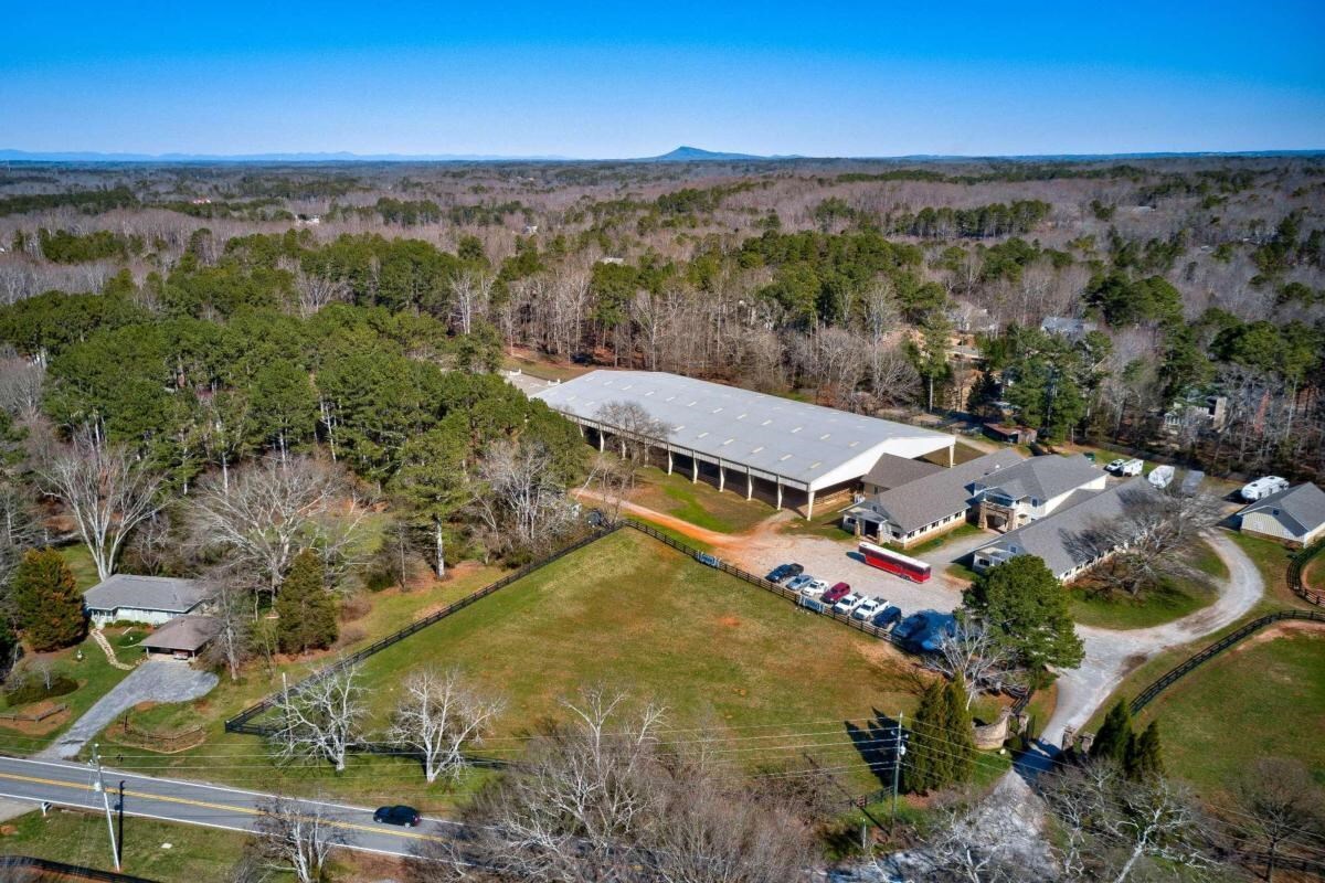 Situated in the heart of Milton, Yellow House Farm offers the ultimate equestrian experience on 18 manicured acres. . The complex features a 20,000 sq foot barn, 38 stalls, 8 wash racks, patron's lounge, office, tack rooms , conference room,multiple bathrooms, laundry facility and upstairs 3 bedroom apartment. The barn leads into a 160x300 covered and lighted arena compared in size to an Olympic Standard equestrian arena., a 140x280 outdoor arena with mirrored side, a hay and equipment barn, additional 6 stall barn, additional turnout paddocks and 7 fenced pastures for ample turnout with double fencing and a bridle trail around the perimeter of the property. . The main barn's stone arches and flooring and wood work makes this barn a world class facility. Large Estate home and additional acreage can be purchased.