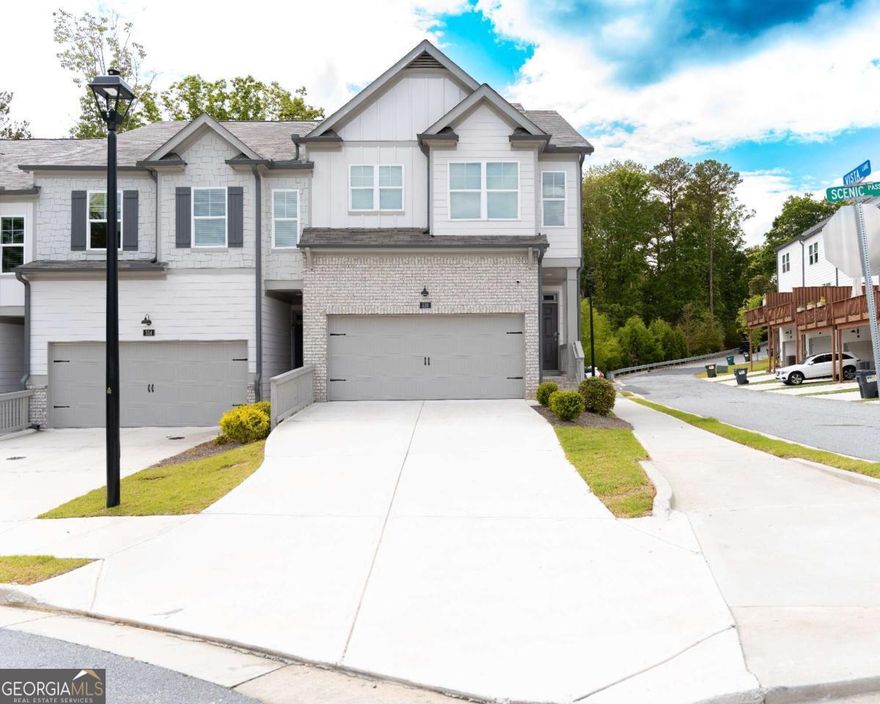 Stunning 4 Bed, 3.5 Bath End-Unit Townhouse in the Heart of Towne Lake    Experience modern luxury in this immaculate 3-year-old end-unit townhouse, ideally located in the vibrant community of Towne Lake. Just steps from Woodstock High School and a short stroll along the Greenprints Trail to downtown Woodstock's shops, restaurants, and entertainment, this home offers the perfect balance of convenience and tranquility.    Inside, you'll find a bright, open-concept main level featuring gleaming hardwood floors, abundant natural light, and thoughtful design throughout. The gourmet kitchen is a chef's dream, complete with white cabinetry, high-end appliances, and a large entertaining island.    Enjoy the ease of main-level entry from your private driveway-no stairs required! Downstairs, the expansive terrace level offers exceptional flexibility-ideal as a fourth bedroom, home theater, guest suite, or ultimate game room.    Upstairs, the luxurious owner's suite includes a spa-inspired bathroom, separate shower, and generous walk-in closet. Three additional bedrooms provide ample space for family, guests, or a home office.    Step outside to a fenced, zero-maintenance yard that backs to lush, private green space-your own peaceful retreat.    With smart home features, designer finishes, and an unbeatable location, this home is truly move-in ready and a rare find.    ?? Don't miss this opportunity-schedule your private showing today and discover upscale Woodstock living at its finest!