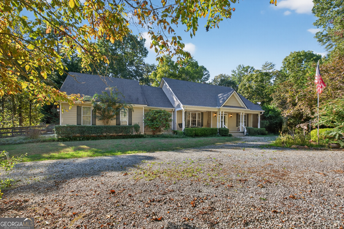If PRIVACY, space for your HORSES to roam, and a beautiful RANCH on a FINISHED basement with an ELEVATOR are on your wish list... this property delivers it all! Nestled on just under 7 ACRES of peaceful countryside, this GATED retreat is perfect for animal lovers and those seeking a serene lifestyle. The property includes a BARN with two STABLES and a fenced PASTURE, offering the ideal setup for horses, farming and exploring. Inside, you'll find an inviting, open floor plan with gleaming HARDWOOD flooring throughout the main living areas. The spacious great room features a stunning stack-stone fireplace, perfect for the whole family to gather around on those cozy nights and the high ceilings allow for that 20-foot Christmas tree! The chef's kitchen sits at the heart of the home and boasts granite countertops, a tile backsplash, stainless steel appliances (including a warming drawer), and a LARGE ISLAND with seating. Adjacent to the kitchen is the formal dining room that can easily sit 12 or more. So much character throughout with crown moulding, chandeliers, a wet bar and picture windows that bring in so much NATURAL LIGHT. Step outside to enjoy the expansive deck or SCREENED-IN covered porch, both perfect for outdoor entertaining or relaxing under the stars. There's even a natural gas line ready for your grill. The oversized primary suite on the main level is a true retreat, offering HIS AND HERS SEPARATE BATHROOMS! I mean, WOW!! Take the elevator down to the finished basement which provides incredible versatility with two additional bedrooms, two full bathrooms, a SECOND KITCHEN (that can easily be expanded), and a flex room that could serve as a family room, office, or gym. You'll also find a cozy fireplace, ample storage and exterior access to the backyard. Notable updates include two new hot water heaters and the roof was replaced in 2019. With space, function, and privacy, this property offers the perfect blend of country living with modern convenience-close to shops, restaurants, and major highways for commuting convenience. Minutes to Crystal Falls golf course. This gated and private property is truly one of a kind-ready to welcome you home!