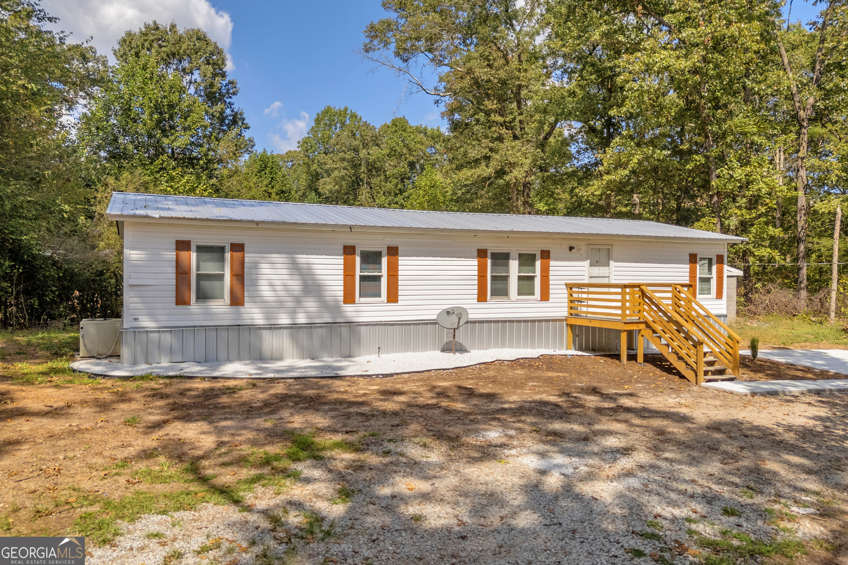 Welcome to your peaceful slice of country living! This fully renovated 3-bedroom, 2-bathroom mobile home sits on a generous 2.46-acre lot, offering privacy, space, and versatility. Step inside to a bright, modern interior with updated flooring, fixtures, and a spacious layout perfect for everyday living. The kitchen opens up to a cozy living area, making it ideal for relaxing or entertaining. Outdoors, you'll love the newly built fire pit, ideal for evening gatherings. With ample parking, a handy shed for storage, and room to farm or garden, this property is ready to fit your lifestyle needs. Located just outside Danielsville, this move-in-ready home offers the perfect balance of rural charm and convenience.