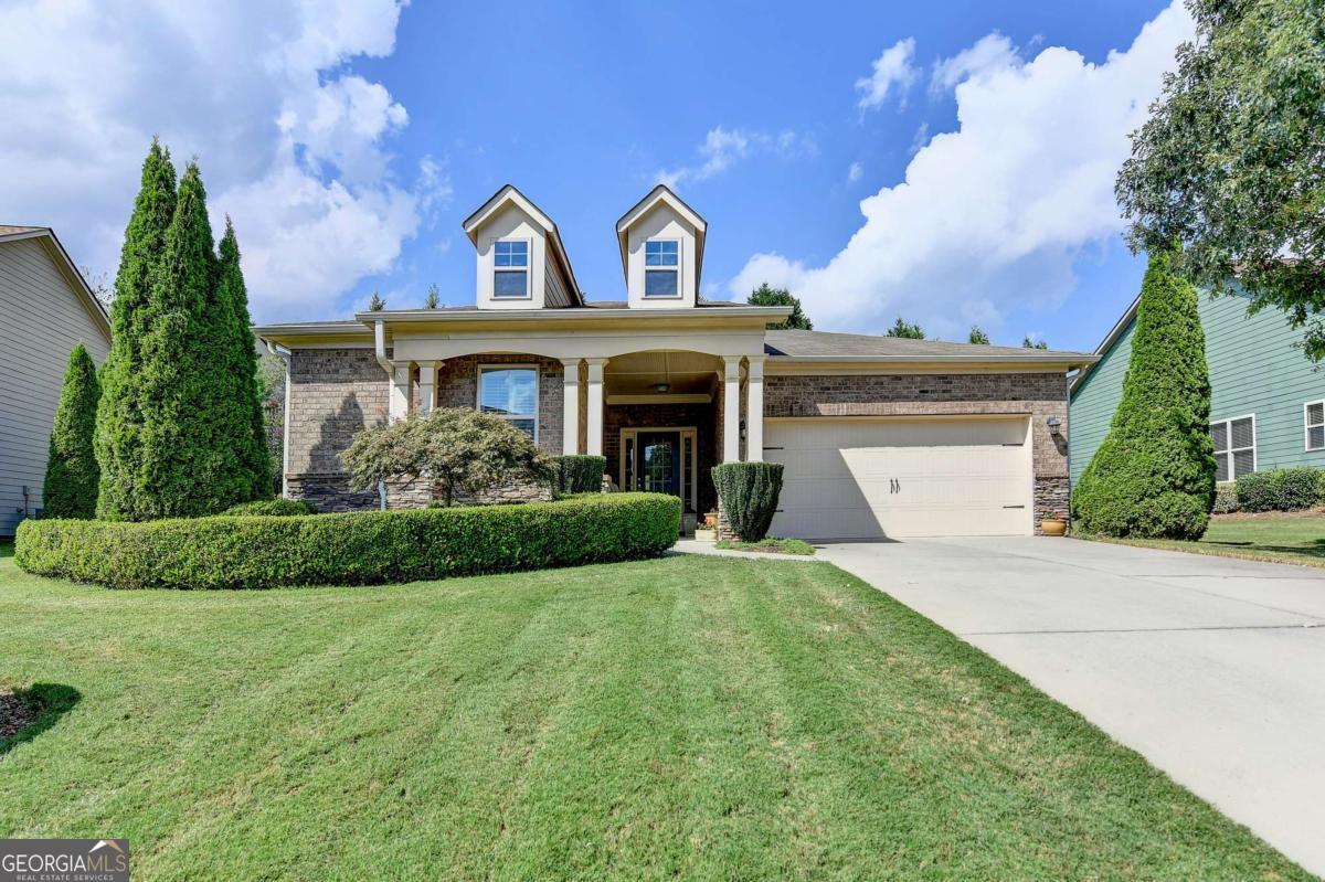 Welcome home to this beautiful craftsman home in Canton. The home features an inviting covered front porch, which provides ease of access for guests. A lovely entry way with custom lighting awaits you. The home features generous sized secondary bedrooms, which makes this floor plan super functional. The home has a drop zone off the garage and a fabulous laundry room with sink. The focal point of the home is an inviting dining room/ great room open to the the kitchen...which features stainless steel appliances, a gorgeous granite kitchen island and tons of cabinets and a great walk in pantry. Plantation shutters on all windows are an incredibly elegant and super functional touch to the home. The owner's suite provides a relaxing retreat at the end of the day... a fabulous en suite bathroom with tons of counter space, double vanity, separate tub and shower and private water closet. The owner's closet provides plenty of space for everything. The best secret is your quiet sanctuary in the screened porch- have coffee and enjoy nature! Hampton Station is a beautiful swim/tennis neighborhood with sidewalks and street lights- the amenities are a great place to relax, unwind and build relationships in this community. Canton is a growing and vibrant area with businesses, recreation and restaurants... easy access to I75/575 and the North Georgia Mountains.