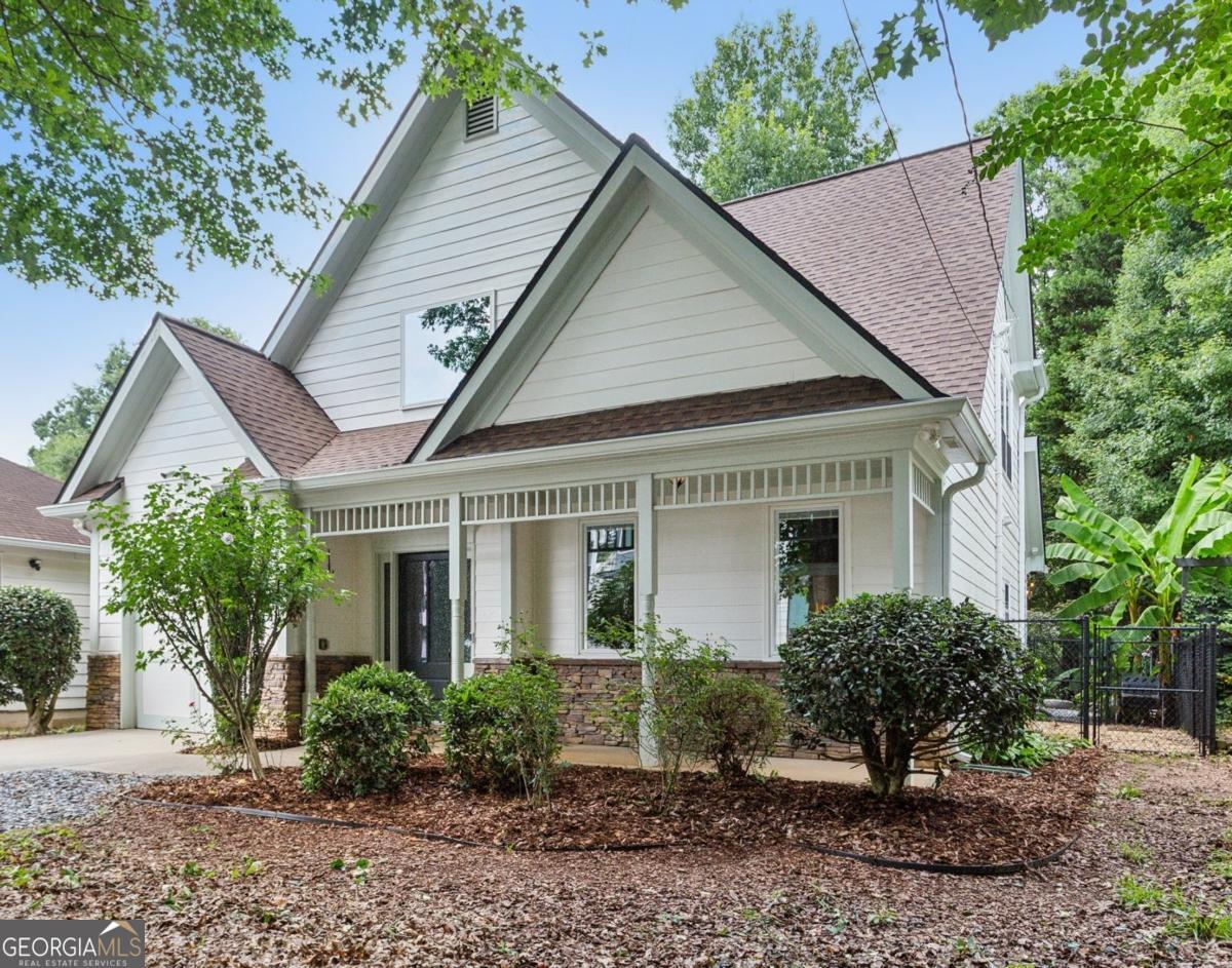 Location, location, location, paired with thoughtful updates and impeccable maintenance make this home the one you'll want. Designed for entertaining, it features a magical backyard complete with a new spa, soft overhead lighting, a spacious outdoor dining area and grilling area with Big Green Egg, a calming water feature, and privacy fence. Your dogs will love the enclosed back yard plus dedicated dog-run on one side of the house, while the opposite side offers raised garden beds, a wall-mounted hose system with a 100-foot hose for watering your planters, and even banana trees soaking up the southern sun. Inside, the home boasts hardwood floors in the vaulted living room, and in the kitchen and dining area. Custom shelves in the living room and mounted 65" Samsung TV. The main-level primary suite features a custom headboard, projector TV with retractable 100" screen, and a spa-like bathroom with separate tub and shower surrounded by tile to the ceiling. Upgraded replacement windows with custom blinds are installed throughout most of the home, including the two upper-level bedrooms. The front windows feature integrated blinds that allow pets to look outside without damaging them. Secondary bedroom #2 includes a queen Murphy bed with a top-tier mattress, a generous double closet, and upgraded windows. Storage is plentiful, with secure plywood floor and lit spaces above the garage and behind both secondary bedrooms, plus a custom drop-down ladder to an additional attic area above the second-floor landing. The garage is a true man cave and workshop in one, featuring a custom epoxy floor, full custom slatwall storage and shelving system, safe, workbench, and Monolift garage door. This home is also a dog-lover's dream, with a custom kitchen door with built-in doggie door, another doggie door from the living room to the enclosed run, and a pre-installed dog gate between the kitchen and living area. Across the street is the dog walker's heaven - Crestlawn Cemetery where the dogs and their hoomans all know each other. Technology abounds with gigabit internet with a Nighthawk distributed satellite Wi-Fi system, full-house CAT-8 Ethernet wiring in all rooms (including TV hookups), and a whole-home security camera system. When it's time to explore, major attractions are just around the corner, including The Works, Topgolf, and fine dining at Bacchanalia. The new largest park in the City of Atlanta, Shirley Franklin Park is minutes away, offering fresh air, skyline views, and connections to the Proctor Creek Trail and Atlanta Beltline. Just half a mile up the street, the Whetstone Creek Trail links you with the Silver Comet Trail, and Westside Village's dining and retail options are an easy stroll up the trail. Convenient to Downtown, Midtown, and Buckhead and all points beyond with easy access to I-75 and I-285.