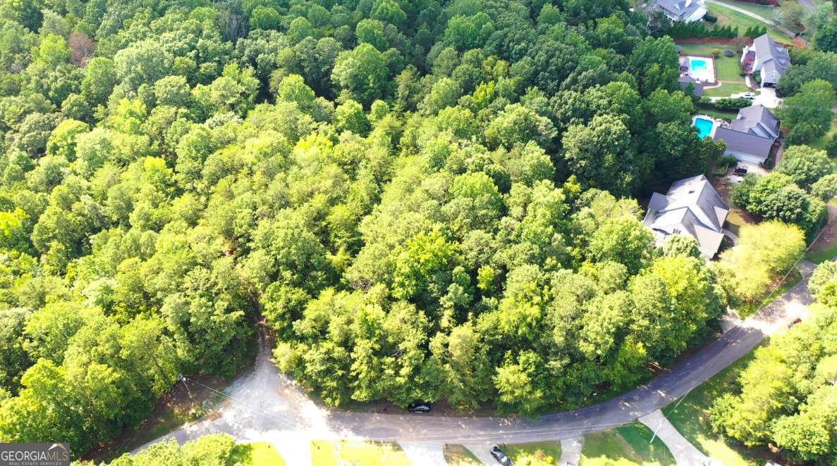 Exceptional 0.768-Acre Homesite Near Lake Lanier - Build Your Dream Estate Discover a rare opportunity to own a private and beautifully wooded 0.768-acre lot nestled in a quiet, established area near Lake Lanier. Located on the desirable Goddards Ford Rd, Lot #61 offers a gentle slope ideal for a basement home and boasts mature hardwoods, creating a tranquil, natural setting for your future custom residence. This homesite is part of a lightly restricted neighborhood with no HOA, giving you the freedom to bring your own builder and vision to life. Soil test, survey, and an expired, but previously approved-construction permit are available. Conveniently located minutes from boat ramps, parks, shopping, and dining, with easy access to downtown Gainesville and major highways. No lake frontage or dock slip-just peaceful living in a sought-after location. Don't miss this opportunity to create a truly personal retreat.