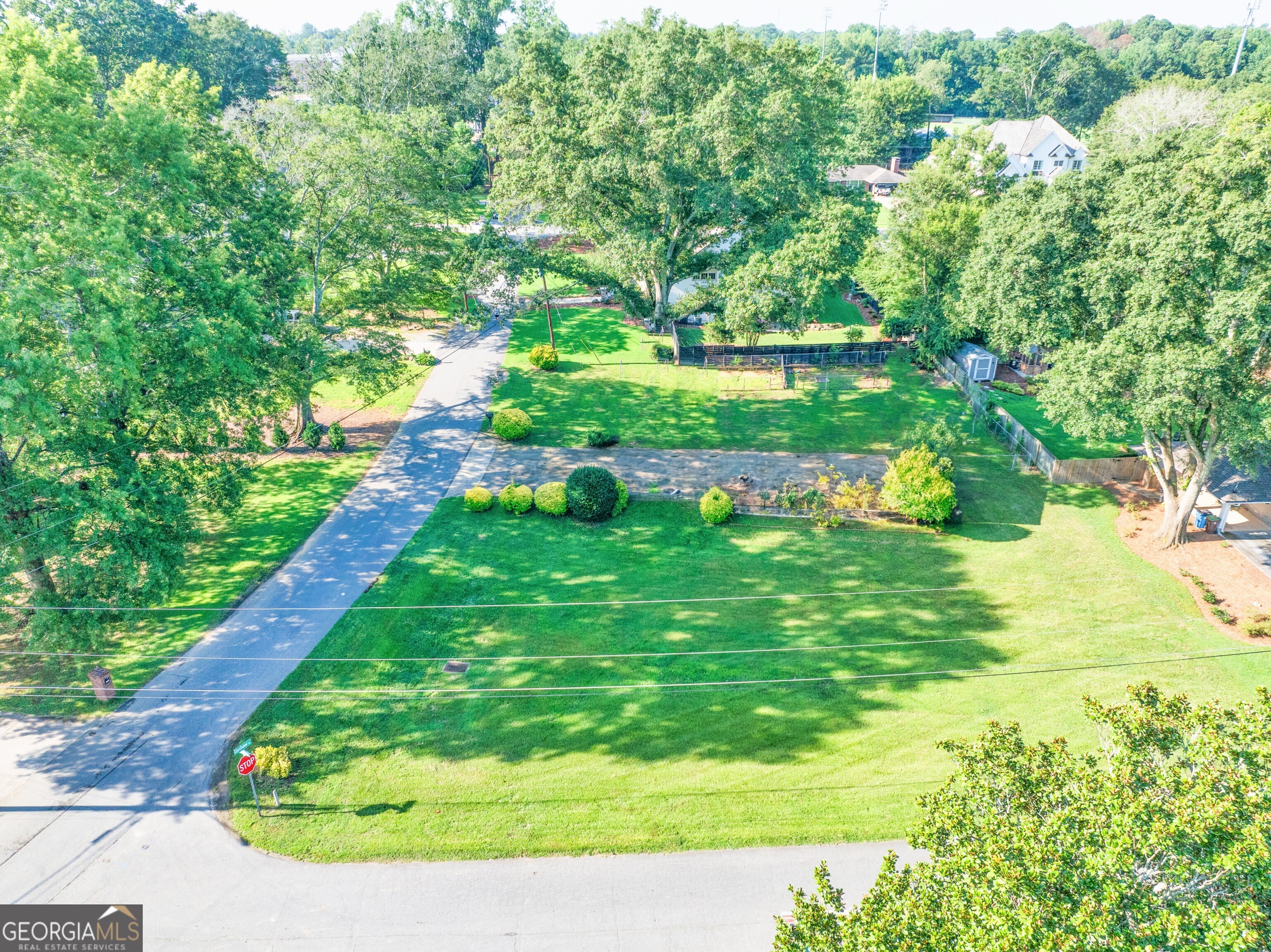 Are you envisioning the perfect home in the heart of downtown Alpharetta? Look no further. This exceptional property, located on a level half-acre corner lot, awaits your custom design. Nestled in a charming neighborhood just a five-minute stroll from downtown, you'll find yourself mere steps from the vibrant Canton Street and Highway 9. Experience the allure of the Avalon, where you can indulge in an array of exquisite restaurants, boutique shops, and engaging events. Additionally, the nearby Ameris Bank Amphitheater offers a fantastic selection of entertainment options. Priced competitively, this opportunity is supported by comparable sales, making it a remarkable choice for your dream home.