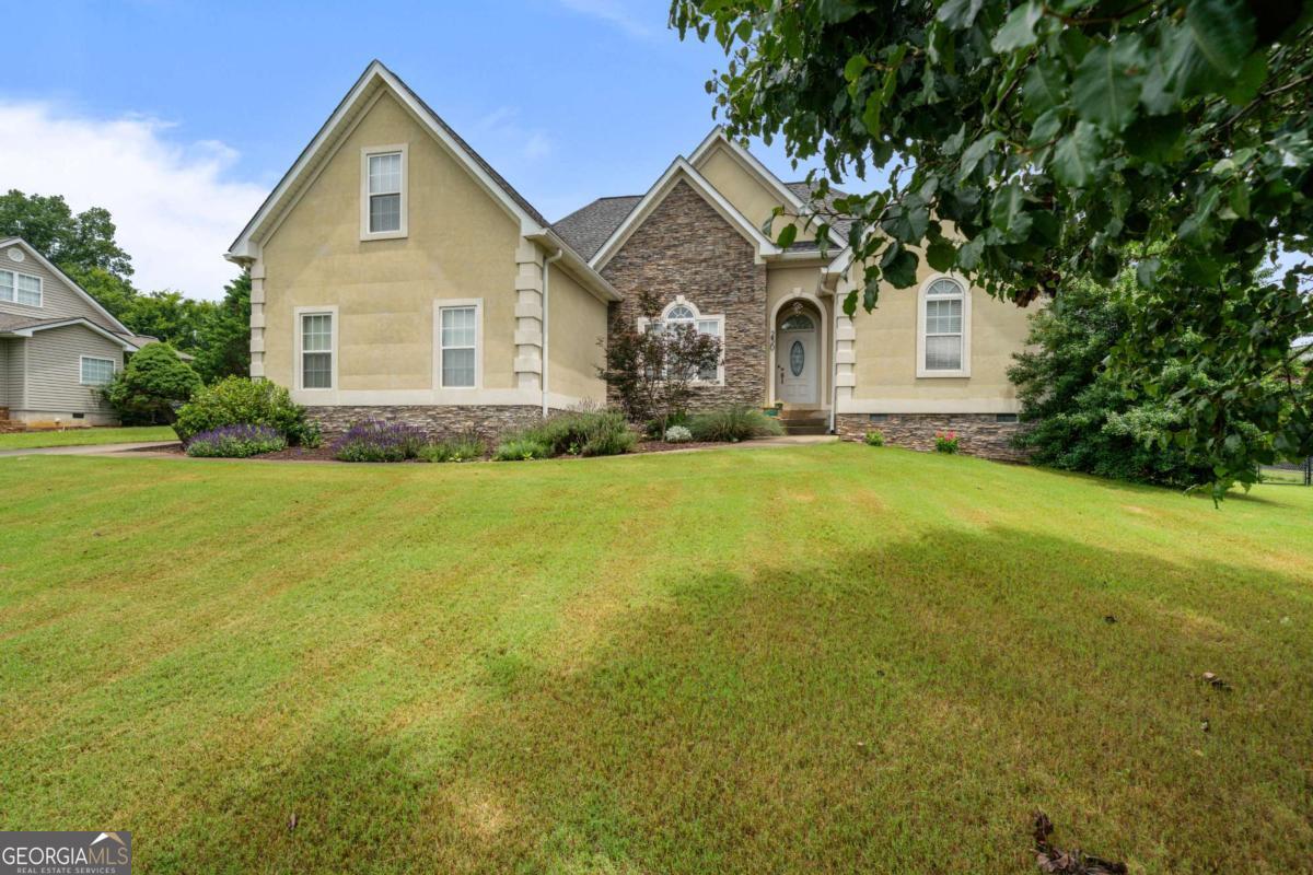 Nestled within The Farm at Hardwood Ridge subdivision in Adairsville, this inviting residence offers a blend of comfort and functionality across 2040 square feet. Situated on a generous 0.53-acre lot, the property provides ample outdoor space for relaxation and activities. The established neighborhood features streetlights and a picturesque pond, perfect for serene views or leisurely fishing. Upon entering, guests are greeted by a well-conceived layout that emphasizes both private retreats and communal areas. The main level is designed for ease of living, featuring a primary suite that provides a comfortable and private sanctuary. This thoughtful design allows for single-level living while offering additional space upstairs for various needs. The kitchen, a central hub of the home, is equipped for preparing meals and hosting gatherings. Adjacent to the kitchen, the dining area provides a dedicated space for meals, while the main living room, complete with a fireplace, offers a cozy spot for unwinding. Hardwood flooring extends throughout much of the main level, contributing to the home's cohesive design and making upkeep straightforward. The residence encompasses four bedrooms and two bathrooms, providing versatile accommodations. The additional bedrooms offer flexibility, serving as guest rooms, home offices, or hobby spaces as needed. Each room is appointed to ensure comfort and privacy, catering to a range of arrangements. The bathrooms are designed with practicality in mind, offering essential amenities. Beyond the interior, the expansive 0.53-acre lot offers considerable outdoor potential. The large yard is suitable for a variety of outdoor pursuits, from gardening to simply enjoying the summer weather. The neighborhood's amenities, including the pond and streetlights, enhance the living experience, providing opportunities for outdoor enjoyment and a sense of community. The property's location in Adairsville ensures convenient access to local offerings while maintaining a peaceful residential atmosphere. This home is a prime opportunity for those seeking a well-appointed property with substantial outdoor space in a desirable community. To learn more about this property or to schedule a private viewing, please contact our team.