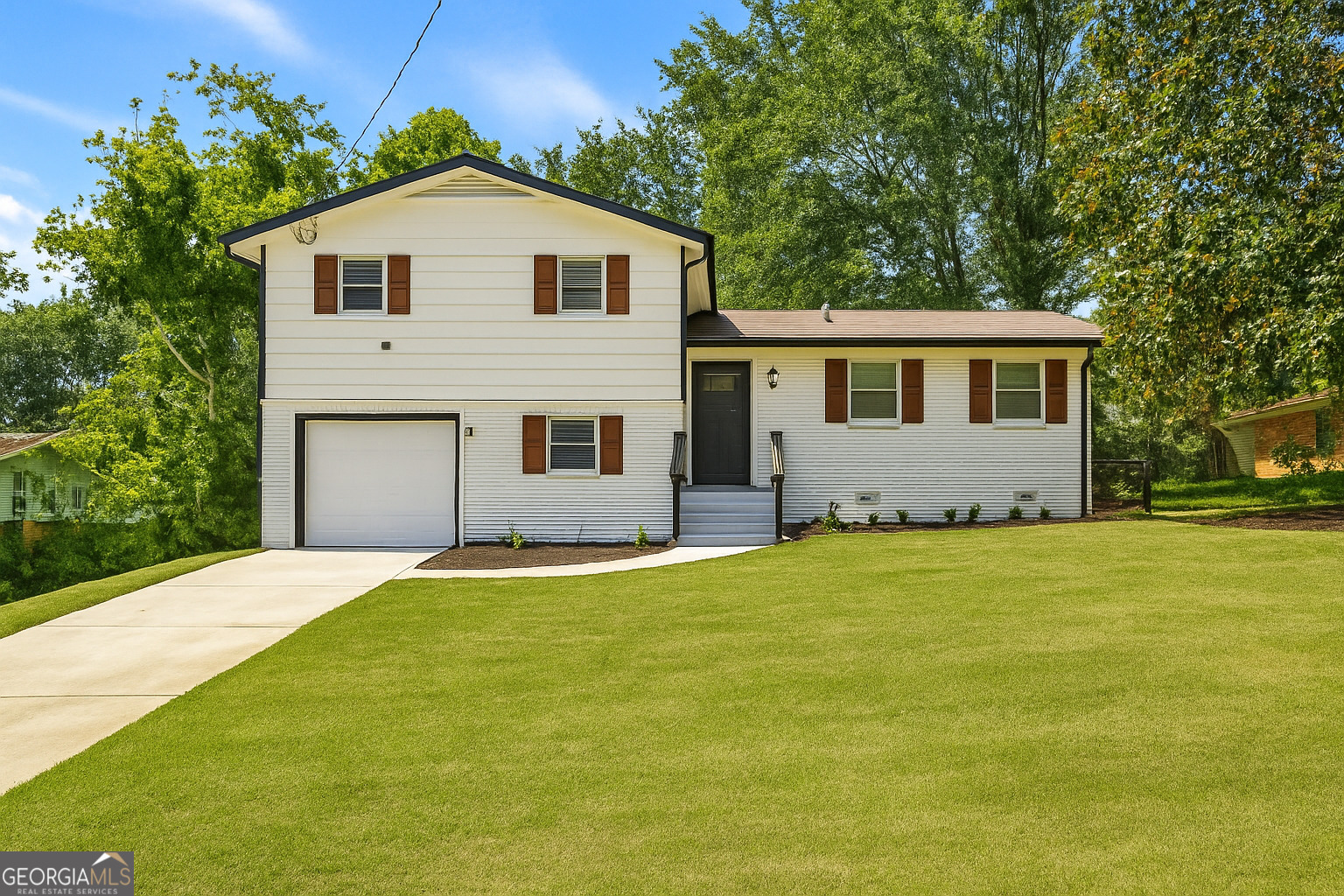 Stunning, fully renovated home located on a quiet cul-de-sac in Decatur's desirable Emerald Estates community-with no HOA! This spacious home features an open-concept layout with luxury tile and waterproof plank flooring, fresh paint, updated trim, and high-end crystal LED light fixtures with ceiling fans throughout. The dream kitchen boasts a massive 12-foot quartz island, luxury quartz countertops, soft-close wood cabinetry with gold accents, and brand-new stainless steel appliances. The primary suite offers a covered private deck overlooking a large, private backyard with an additional deck for entertaining. Each bathroom features floor-to-ceiling tile and rainfall showerheads. The finished lower level includes two bedrooms, a large living space, and a separate exterior entrance-ideal for income-producing potential, in-law living, or guest accommodations. Renovated storage shed in the backyard.