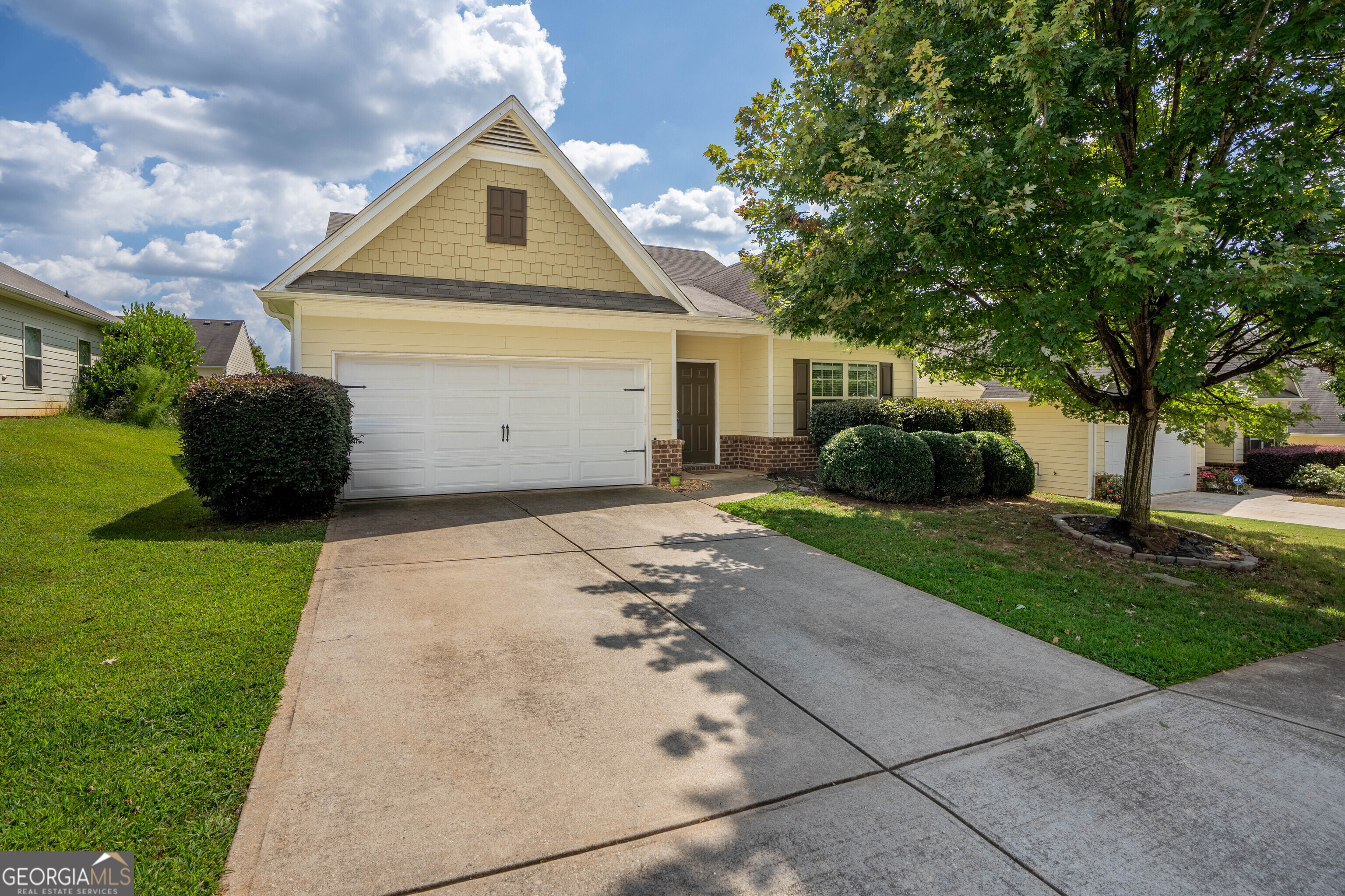 Welcome home to the perfect blend of comfort, style, and convenience! This 3 bedroom, 2 bath beauty has been meticulously maintained and offers an open-concept design that feels bright and inviting from the moment you step inside. The wide foyer sets the tone, leading you into a spacious family room filled with natural light. Overlooking the living area is a chef-inspired kitchen featuring sleek granite countertops, an oversized island, and a walk-in pantry big enough to keep everything organized. Whether you're hosting friends or enjoying a quiet night in, this open layout makes entertaining effortless. The owner's suite is a true retreat, complete with a soaking tub, separate shower, and a thoughtfully designed vanity space. Two additional bedrooms provide plenty of flexibility for guests, children, or even a home office. Step outside to the fenced backyard, perfect for pets to roam or kids to play safely. A separate laundry room, 2-car garage, and low-maintenance hardie plank with brick exterior add function and curb appeal. Located just minutes from Flowery Branch, you'll be close to shopping, dining, and everyday conveniences. Plus, with an elementary school right inside the neighborhood, this home checks every box!