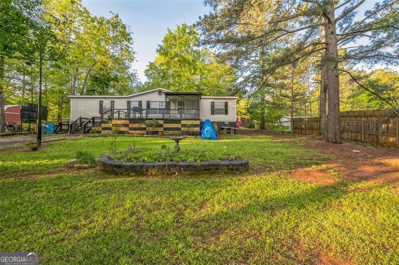 Welcome to your new lake retreat! Step inside this cozy mobile home, situated on a generous half-acre lot that offers an elevated, picturesque view near Lake Jackson. The spacious living area is bathed in natural light, making it the perfect spot to relax and take in the scenery. The property offers ample outdoor space for gardening, outdoor entertaining, or simply enjoying the peaceful, serene environment. Located just minutes from fishing, boating, and local conveniences, this property offers an unparalleled combination of affordability and lakeside living.