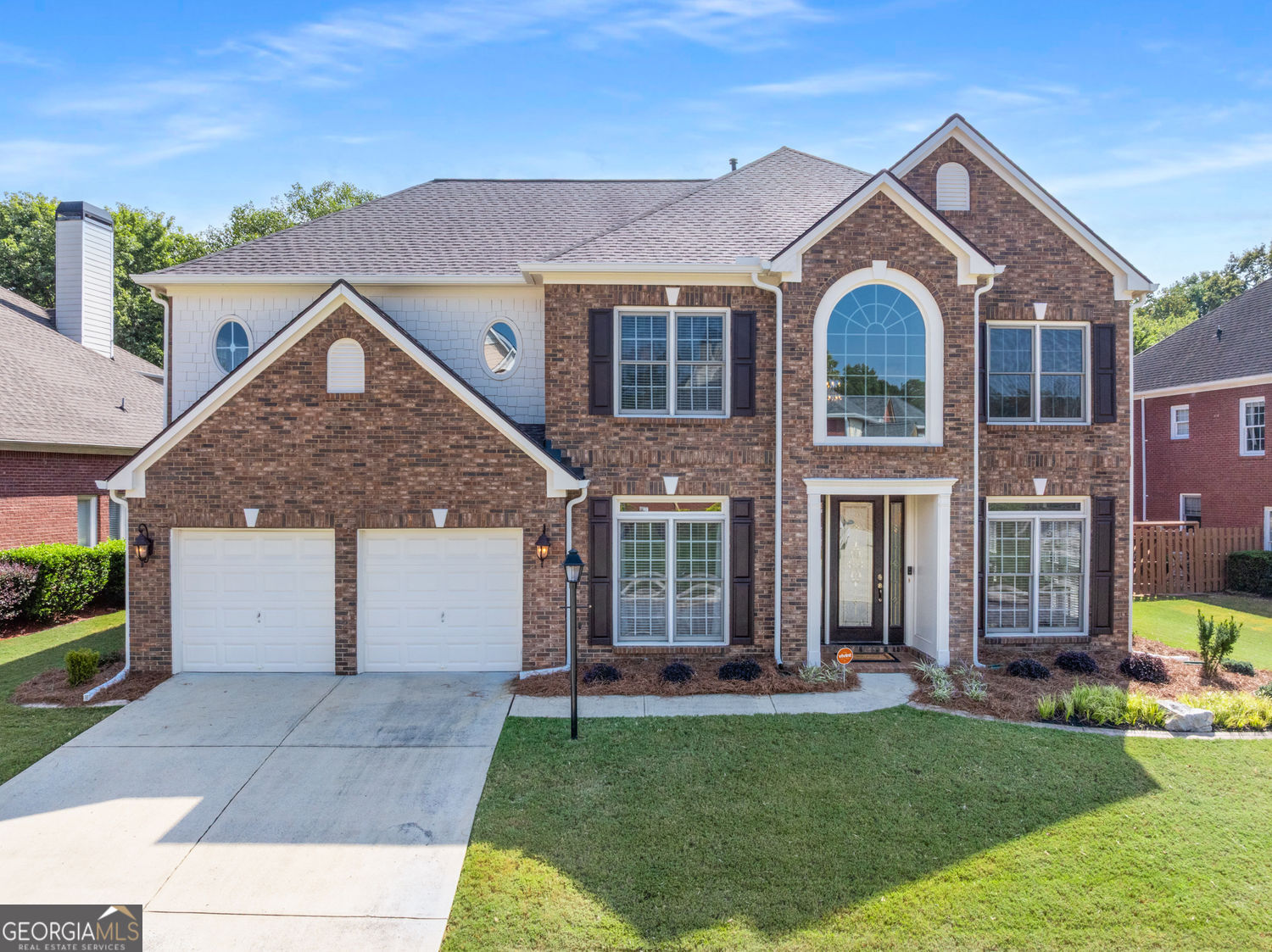 This impeccably maintained home in Smyrna's Woodland Gate neighborhood will not disappoint! Truly in move-in condition, featuring an updated kitchen and primary suite bathroom, as well as $105k+ in updates & improvements. The exterior is 3-sided brick with hardiplank siding and was professionally landscaped in 2024 & 2025. Inside, there's a 2-story foyer and living room with UVA tinted glass, open to the adjacent formal dining room. The remodeled eat-in kitchen features granite countertops, subway tiled backsplash, stainless steel appliances, double ovens, gas cook top with an exterior vent, and white cabinets with an accent center island. The kitchen is open to the family room featuring a gas fireplace and walls of windows, and leads to the screened porch. The living areas on the main floor feature gleaming hardwood floors and there are 9'+ ceilings throughout all levels. The guest suite on the main floor is perfect for visitors or a home office while the garage is extra deep with bonus space and has plenty of room for storage, a workbench, workshop or flex space. Upstairs you'll find 4 additional large bedrooms plus a workplace loft. The oversized primary suite has a fireplace and separate sitting room, trey ceilings, a completely remodeled bathroom with white subway tiled shower, new fixtures, frameless glass shower door, new tile floor, soaking tub, lighting, professionally painted vanities and dual sided walk-in closets. Each of the three additional upstairs bedrooms feature large closets. A laundry room with utility sink, and a loft with built-in work space complete the rest of the second floor. Additional features and updates include a new 30-year architectural roof and gutters (2025); 11 new windows (2025); new water heater (2025); interior & exterior painting; recent interior carpet, garage door openers; and hardwood floors. The neighborhood features a swimming pool and tennis courts and is adjacent to a large playground, with excellent access to interstates, shopping, dining, Truist Park and the Silver Comet Trail.
