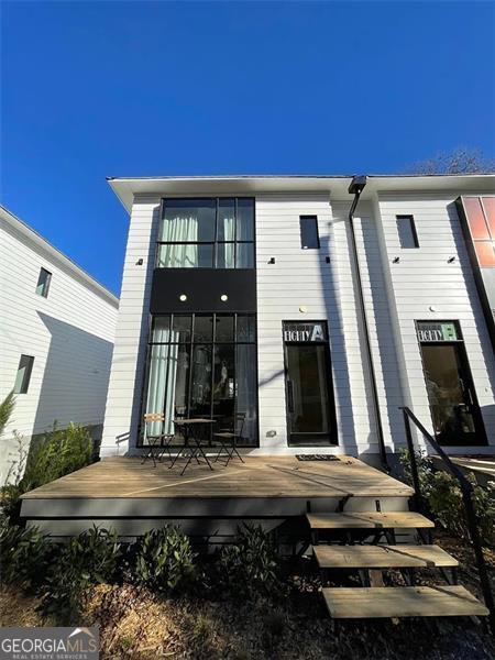 Discover the perfect blend of style, comfort, and location with this fully furnished Midcentury Modern townhome available for lease at $4,000/month. Located directly on the Atlanta BeltLine in the heart of Reynoldstown, this two-story green-built home offers thoughtful design, natural finishes, and unbeatable access to Atlanta's most vibrant neighborhoods. From the moment you arrive, the charm is unmistakable. A fully fenced front yard leads to a spacious covered front porch, perfect for morning coffee or evening relaxation. Inside, soaring ceilings and floor-to-ceiling windows fill the home with natural light, highlighting the open-concept layout that effortlessly connects the dining area, expansive living space, and chef's kitchen. The kitchen is a true showpiece, featuring quartz countertops and backsplash, soft-close two-toned cabinetry with brass hardware, an induction cooktop, paneled dishwasher, and a large island with modern pendant lighting. There's even a built-in dog nook, thoughtfully integrated for your furry companion. Hardwood floors lead to the living area and a cozy alcove ideal for a desk or reading corner. Step outside to a massive covered back porch with direct BeltLine access-an extension of your living space that invites year-round enjoyment. A convenient half bath completes the main level. Upstairs, the spacious secondary bedroom includes a walk-in closet and en suite bath with eclectic wall tile and a shower/tub combo. The private primary suite is a tranquil retreat, featuring double French doors, room for a sitting area, a peaceful private patio, and a luxurious en suite bath with a walnut double vanity, elegant dimmable sconces, a glass walk-in shower, and brass accents. The large walk-in closet provides excellent storage, and a laundry area and linen closet complete the second floor. Additional highlights include a rare tandem two-car garage with extra storage and a guest parking pad. The home is east-west facing, ensuring beautiful natural light throughout the day. Just moments from Krog Street Market, Reynoldstown Farmers Market, Lang-Carson Park, and some of Atlanta's top restaurants, shops, and entertainment venues-including Ponce City Market, Madison Yards, Atlanta Dairies, Gunshow, Breaker Breaker, and Muchacho-this location truly delivers. With quick access to MARTA and major highways, this exceptional home offers effortless city living in one of Atlanta's most dynamic communities. Move-in ready and fully furnished, it's a rare leasing opportunity you won't want to miss.