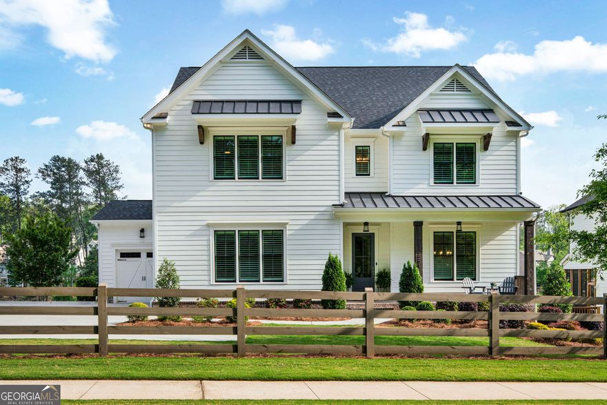 Welcome to the home that has it all luxury, location, and lifestyle. Nestled in the highly sought-after Ellis community, just minutes west of the vibrant Marietta Square and located within the desirable West Cobb school district, this 5-bedroom, 4-bathroom stunner is where refined design meets everyday ease. Built in 2020 by the esteemed Waterford Homes, this property is a modern masterpiece with timeless appeal. Step inside to find gleaming hardwood floors, plantation shutters, and designer finishes throughout. The open concept main living area is light-filled and inviting, anchored by a bright, airy living room that offers serene views of the picturesque community pond. A formal dining room sets the stage for elegant entertaining, while the oversized quartz island and chef-inspired kitchen deliver everyday function with elevated style. Need a flexible layout? The main-level bedroom with adjoining full bath is the perfect guest suite or office escape. Upstairs, the spacious primary suite is your private sanctuary complete with a soaking tub, oversized mosaic-tiled shower, dual marble vanities, and a dream walk-in closet with custom built-ins for your inner fashion lover. Two additional bedrooms share a stylish Jack and Jill bathroom, while a fourth upstairs bedroom enjoys privacy and access to another full bath. Step outside to enjoy double decks with tranquil pond views ideal for morning coffee, evening wine, or just soaking in the peaceful surroundings. The full daylight basement is ready for your personal touch, while the 3-car garage (including a boat door!) and irrigation system check every practical box. Ellis offers an unmatched lifestyle with amenities including a clubhouse, resort-style pool, tennis courts, pickleball courts, and scenic nature trails. Whether youCOre casting a line in the pond or hosting on the back deck, this home invites you to live, relax, and thrive.