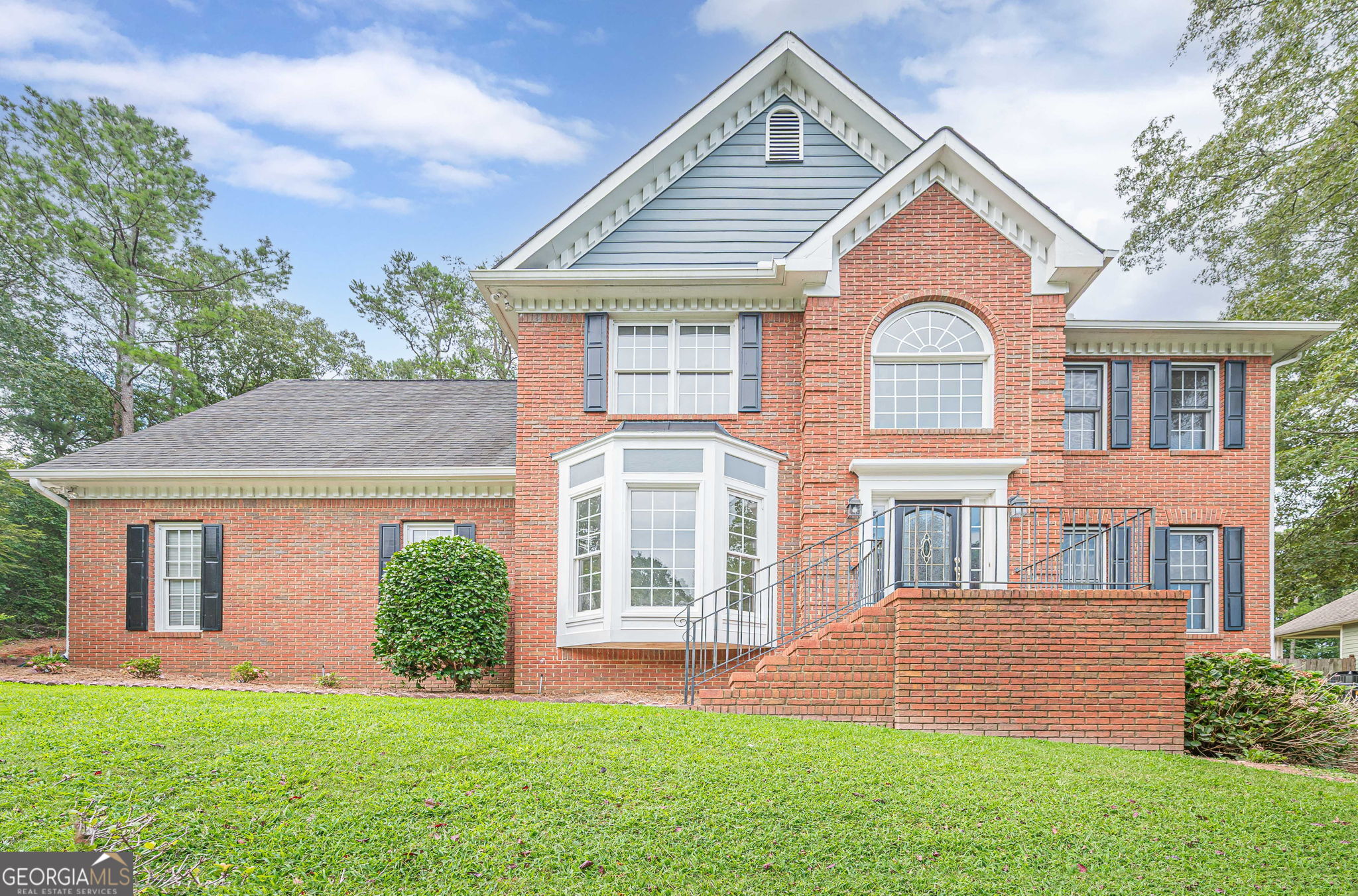 Location, Location, Location! Welcome to this spacious and stately brick traditional home on a large .65 acre lot nestled in the highly desirable Towne Lake area of Woodstock AND just 3 minutes to the Lake Allatoona boat launch! This move-in ready home offers 5 large bedrooms, 3.5 bathrooms, and a fully finished basement apartment with a private entrance and flexible living space making it perfect for multi-generational living or the savvy real estate investor. Notable updates include, fresh interior paint, brand new carpet and ceiling fans, 2-year-old dual HVAC system & water heater, freshly painted kitchen cabinetry, stainless steel appliances & a built-in desk. New tile flooring in the oversized laundry room and upstairs bath. The main level features formal living and dining rooms, an open-concept kitchen and family room with hardwood flooring plus a versatile laundry room that could double as a home office or pantry. Upstairs, you'll find five spacious bedrooms, including a huge bonus room (5th bedroom) all with walk-in closets and new carpet. The terrace-level in-law suite boasts a full kitchen, breakfast area, washer/dryer hookups, private entrance with a dedicated walkway, and three additional finished rooms, ideal for use as bedrooms, a media room, or a home gym. The extra-wide driveway provides ample resident and guest parking. Located directly across from Hobgood Park and within walking distance to the scenic trails and recreation. This home's unbeatable location is only 1.5 miles to Lake Allatoona, 2.5 miles to Eagle Watch & Towne Lake Hills Golf Clubs, 5 miles to BridgeMill Athletic Club, 6 miles to Downtown Woodstock & I-575, 7 miles to I-75, 15 minutes to Kennesaw State University and all shopping and dining options Towne Lake has to offer! Situated in the top-rated Etowah High School district, this rare gem offers the perfect blend of space, updates, and location. Don't miss your chance to make this Towne Lake beauty your new home!