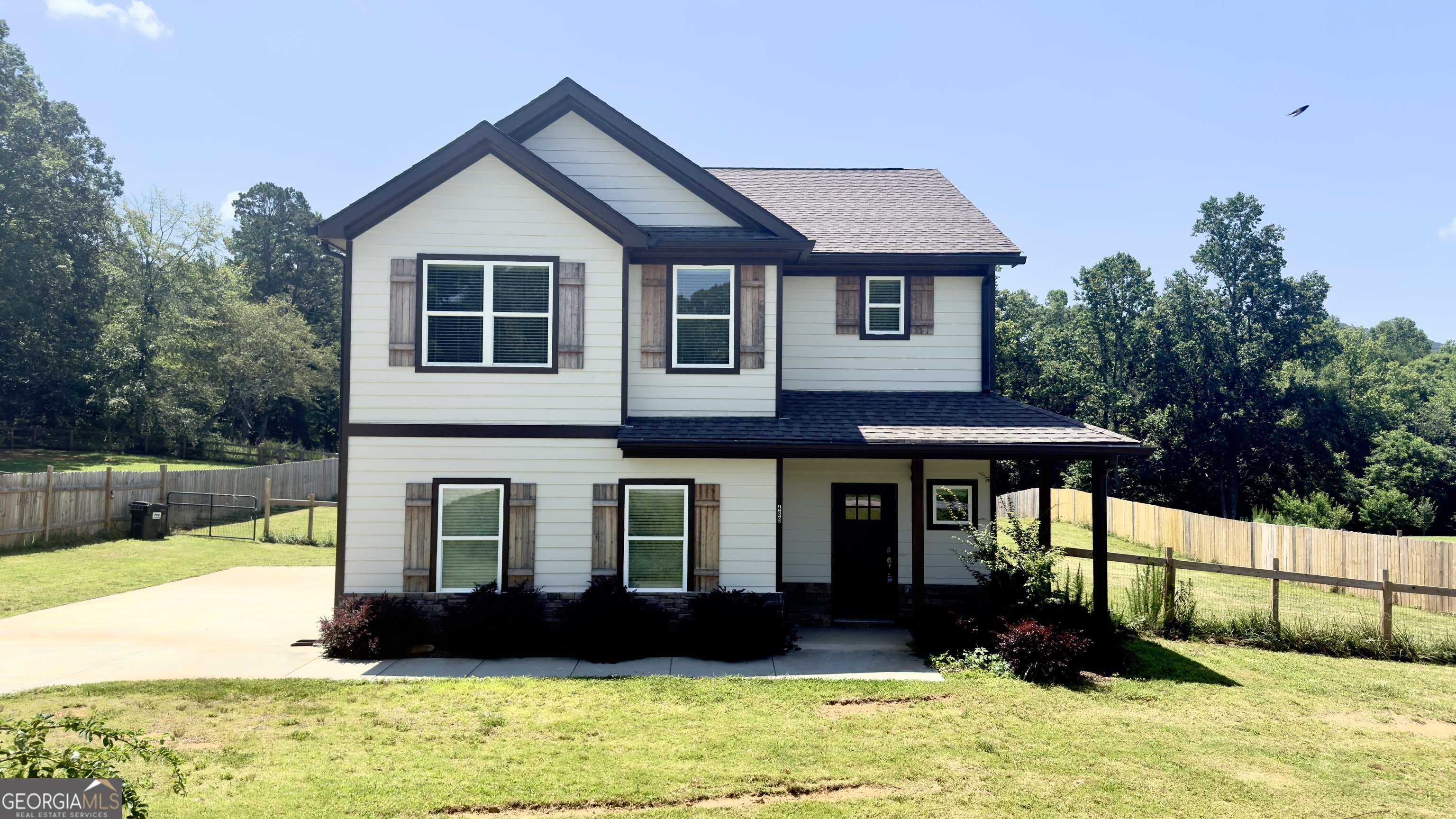 Modern 4-Bedroom Home on 1 Acre with Outdoor Fireplace - Convenient Location!! Welcome to this beautifully designed 4-bedroom, 2.5-bath home built in 2022, perfectly situated on a level 1-acre lot just minutes from downtown Cleveland. Featuring an open floor plan and stylish modern finishes throughout, this home offers the ideal blend of comfort, functionality, and charm. Step inside to find laminate flooring throughout and a popular neutral paint palette that complements the upgraded light and plumbing fixtures. The oversized living room features a stunning rock fireplace and flows seamlessly into the chef's kitchen, complete with a large island, farmhouse sink, solid surface countertops, stainless steel appliances, and a spacious walk-in pantry. Enjoy meals in the dining area, which opens to a walk-out patio with a cozy outdoor fireplace-perfect for entertaining year-round. Upstairs, you'll find four generously sized bedrooms, two full baths, and a convenient laundry room. The master suite is a private retreat with a large walk-in closet and a spa-like en suite bathroom featuring a custom tile shower and double vanities. The open backyard is fenced for privacy, making it ideal for families, pets, or hosting guests. Located close to schools, restaurants, and shopping, with a short drive to Helen and easy access to Hwy 400, this property offers both convenience and lifestyle. Don't miss the opportunity to make this stunning home your own!