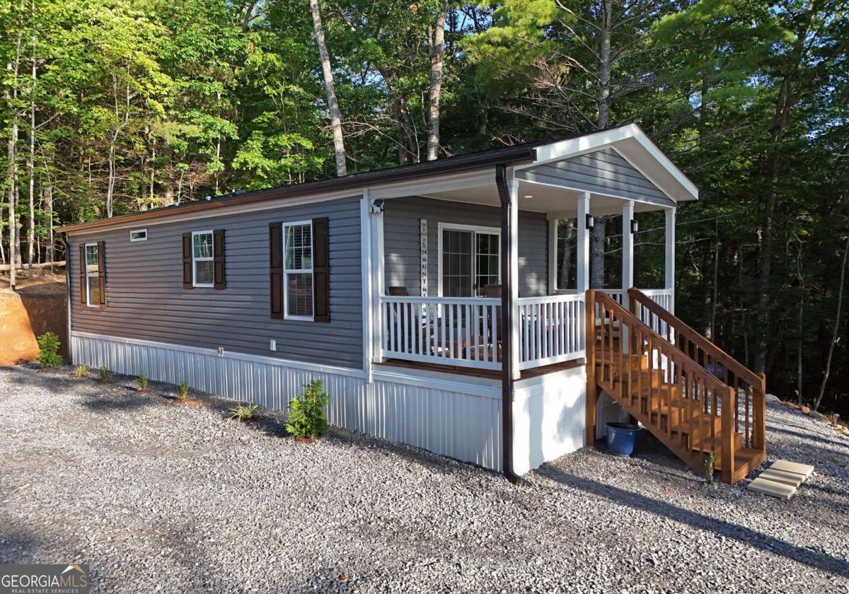 Brand-new 2024 construction on 3.04 unrestricted acres with breathtaking year-round mountain views! Private and secluded, yet just 5 minutes to downtown Blairsville and 15 to Blue Ridge. Room to grow with potential for additional buildings. Features include stainless steel appliances, indoor furniture included, underground power, city water, and a long private driveway-AWD access only. Easy access off Hwy 515. A rare blend of privacy, views, and convenience!