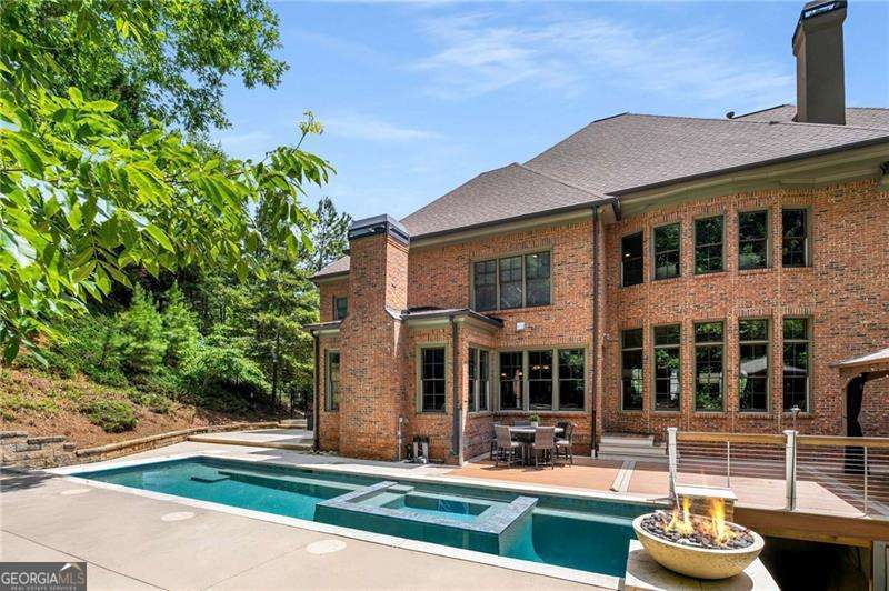 JUST LISTED with a POOL!!! Edinburgh's most prestigious custom home in Bear's Best award-winning golf course community designed by Jack Nicklaus and offers three levels of extraordinary living and elegance. This exquisite home offers 7 spacious bedrooms ,7 bathrooms and 4 fireplaces. With a luxurious backyard oasis this home is meticulously maintained providing a tranquil setting .There's a gorgeous saltwater heated pool and hot tub . Perfect for outdoor dining and relaxation. Upon entering a foyer with high ceilings this home offers abundant natural light that highlights the intricate architectural details. The open-concept living areas are perfect for both entertaining and everyday living, featuring a chef's gourmet kitchen with high-end appliances ,refrigerator , mudroom, walk-in pantry and a stylish breakfast room with leading to the deck. The keeping room boasts a cozy stacked stone fireplace and vaulted ceilings. The Living Room has built-in bookshelves and another fireplace. Large dining room perfect for entertaining. The study is located on the main floor with paneling. The primary suite is a true retreat with a private sitting area , a lavish en-suite bathroom with double vanities, a soaking tub, and a separate shower and an extra-large closet . Each of the additional extra-large bedrooms upstairs are thoughtfully designed large bathrooms . Also, has a playroom or bonus area with a wet bar. The finished terrace level has a ton of natural lighting with windows and doors for an in-law suite with 2 bedrooms, full kitchen , office ,laundry room ,full bathroom , billiards room with pickle ball court and fireplace. This is an entertainer's dream home perfect for gatherings and outside you have a covered gazebo for dining . Don't miss this rare opportunity to own a piece of paradise. Edinburgh is a golf cart friendly neighborhood and offers fantastic amenities, including an Olympic-size pool, a waterslide, tennis courts, a fitness center, a playground and a basketball court. The very active homeowners' association plans multiple social events throughout the year. The neighborhood is moments from the Chattahoochee River, a short ride to Suwanee Town Center, Lake Lanier, destination shopping, dining and entertainment. All this in North Gwinnett's award winning schools. Riverside Elementary, North Gwinnett Middle School and North Gwinnett High School. HURRY THIS HOME WON'T LAST LONG!