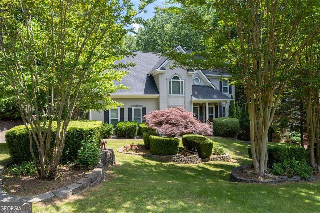 Country Club Living in the Heart of Woodstock! Welcome to a home that offers more than just a place to live-it's a lifestyle! Located in one of Woodstock's most desirable Swim-Tennis-Golf communities, EAGLE WATCH with lite sidewalks, walking trails, large lots, and top-rated schools! Tucked away on a peaceful cul-de-sac street, this Beautifully Updated 4-bedroom, 3.5-bath estate blends timeless elegance with thoughtful functionality and versatility! From the moment you arrive, you're greeted by professional landscaping, a long driveway with ample parking, and a side-entry garage complete with workbench and custom shelving. The New Roof, Gutter guards, Sprinkler System, Freshly sealed Stucco and Fresh paint thruout are Perfect for beauty, long term protection and Peace of mind! Inside, you will be greeted by a dramatic two-story foyer, genuine FRESHLY refinished hardwoods on both main and upper levels! The sunlit family room is anchored by a striking stone fireplace! The Separate Dining Room is large with a beautiful view and the luxurious backyard! The Chef's kitchen features ultra-rare European cabinetry, Dual ovens and Dual new STAINLESS STEEL Refrigerators, Solid Surface Countertops, and a spacious Breakfast area opening to your Private Upper Deck-ideal for morning coffee and evening delights! Upstairs, the oversized Owner's suite features HighTrey Coffered Ceiling, a Cedar-lined walk-in closet and newly Upgraded Bathroom with Marble finishes! Two additional bedrooms with its full bath is an absolute delight for any size family! A laundry room on the second floor adds everyday ease and convenience. Storage is abundant! Downstairs, the fully finished spacious basement offers a bathroom, two rooms perfect for a Media room, Fitness Gym or Office! It includes walk-out access to a second private deck-perfect for entertaining guests or multi-gen living! Your Private Luxious Backyard Oasis is truly something special! Professionally landscaped with stacked stone accents, mature vines, and the feel of a hidden villa in the hills of Italy, it's a place to relax, play, and dream! The fenced yard includes a play set and backs to a tranquil wooded valley leading to a creek-with deer sightings and nature at its finest! This is more than a home-it's where your next chapter begins!!