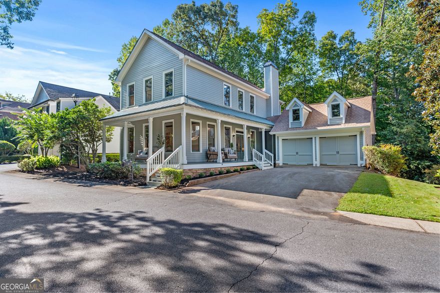 Quaint cottage style home in the sought-after Towne Lake Hills North golf course community tucked away in the private street section of THE ENCLAVE. These homes don't come available very often!  This beautifully remodeled 3-bedroom, 3.5-bathroom home offers timeless character blended with fresh updates throughout. From the moment you arrive, the wrap-around porch and charming curb appeal set the tone for this special property. Step inside this warm and inviting retreat where nature takes center stage. Rich knotty pine walls and accents along with ceilings details that bring a rustic authenticity, while hand-selected cherry wood and timeless hardwood floors create a foundation of elegance. Overhead, reclaimed genuine antiqued timbers from Pennsylvania-repurposed into stunning mantels and ceiling beams-add history, craftsmanship, and character to every room. The blend of wood tones, textures, and natural finishes gives the home a soulful, organic feel-like living in harmony with the forest, wrapped in warmth and timeless beauty.  refinished hardwood floors, and fresh interior and exterior paint. The main level features a warm and inviting living room with a fireplace, a spacious dining area, and an eat-in kitchen that overlooks the wooded backyard and golf course. Step outside to the back deck, where you'll enjoy peaceful views and plenty of space to relax or entertain. Upstairs, you'll find the oversized primary suite, a secondary bedroom, and a versatile office/bonus room-perfect for remote work, hobbies, or a playroom. The finished basement expands your living space even further, offering a private bedroom with custom built in bed and gorgeous built ins, two closets and full bathroom, along with a walkout patio ideal for guests or entertaining. The basement also has a mirror filled workout room, large cedar closet and built in sauna. Additional highlights include a detached two-car garage and large backyard backing up to the golf course.  Large back deck overlooks woods and golf course.  Thoughtfully updated finishes that make this home move-in ready. ALL NEW EXTERIOR AND INTERIOR PAINT. WATER HEATER NEW 2021.  All of this in a prime location with access to golf, swim, tennis, pickleball, swim team, playgrounds, restaurant, and top-rated schools-just minutes to shopping, dining, parks, and Lake Allatoona just minutes down the road. Just 4 min drive to Downtown Woodstock.