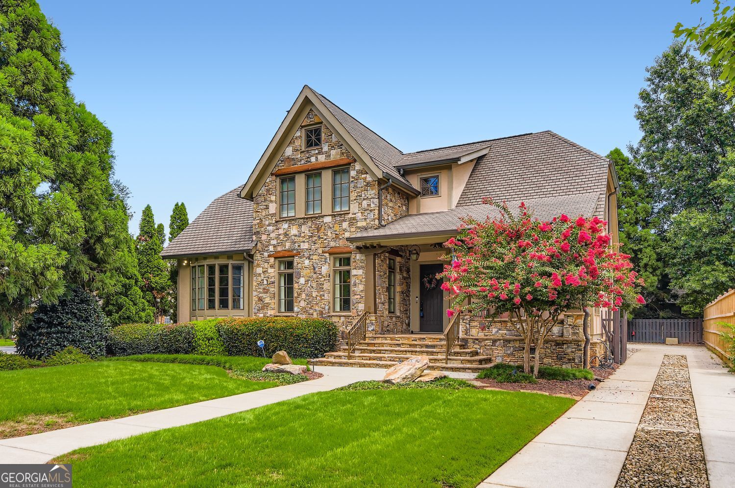 Picture-Perfect Luxury in Prime East Lake Location! Classic design meets modern sophistication in this immaculate 4BR/3.5BA showcase home, built by renowned Woodward Rhodes and located just steps from East Lake Golf Club and within Tier 1 for Drew Charter School. This previous model home/entertainer's dream features a flowing open floor plan filled with natural light, high-end designer finishes installed by HGTV and luxe details throughout - hardwood floors, crown molding, plantation shutters, stunning two-sided fireplace connecting the dining room and living room with additional one in the vaulted great room. The eat-in kitchen shines with stainless steel appliances, granite countertops, spacious cabinets, butler's pantry, wine rack and breakfast bar - all open to the great room. Main level primary suite offers a spa-like bath, custom walk-in closet and plenty of light. Lots of storage including pull down attic stair area and four walk-in attic storage spaces in two guest bedrooms! Additional feature are the not to be missed Norman Top Down Bottom Up Honeycomb cordless shades with blackout features as well - streamlined, safe, and multi-purposed. Enjoy a charming rocking chair front porch, a vaulted stone floor screened-in porch connecting to the garage - don't miss the finished bonus room above! Professionally landscaped, fenced back yard and gated driveway. Moments to 2nd & Hosea, Oakhurst Village, Kirkwood, Decatur, Pullman Yards and more - plus quick access to I-20. This East Lake gem truly has it all!
