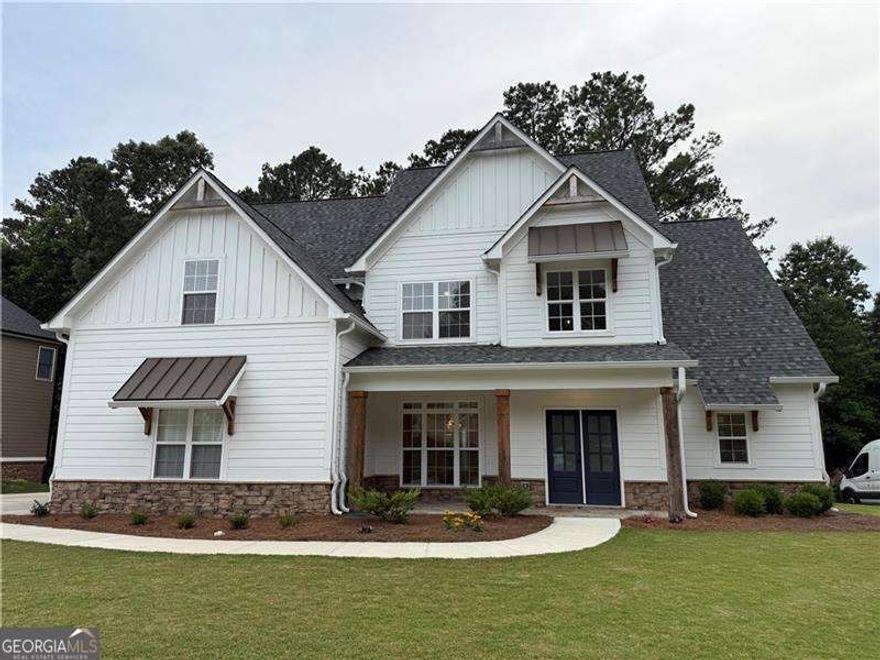 ***LIKE NEW***  Welcome to 72 Hanover Drive, a beautifully crafted 5-bedroom, 3-bathroom home in the highly sought-after Georgian community of Villa Rica. Built in 2023, this home offers a striking two-story foyer that sets the stage for the thoughtful design and upscale finishes throughout. The kitchen features an oversized island perfect for entertaining, upgraded white cabinetry, and sleek granite countertops. The primary suite offers a spacious bedroom with a tray ceiling that adds depth and character. The en-suite bath includes tile floors and a walk-in tile shower, quartz countertops, a freestanding tub, and a generous walk-in closet. Throughout the home, you'll find upgraded trim, cabinetry, and fixtures-all showcasing attention to detail that will be very apparent as you walk through your new home. Located in a vibrant community with resort-style amenities, this home blends comfort, style, and quality. You don't want to miss out on this one!