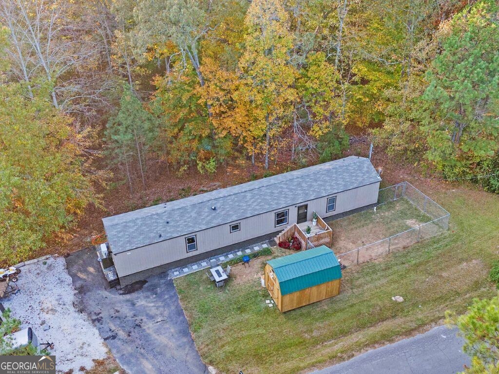 Welcome to serene mountain living just outside Red Top Mountain State Park. This one year young home is move-in ready. Open concept throughout the living area. Step inside the vaulted family room, which opens to the kitchen & dining area. The kitchen is equipped with ample cabinetry and counter space, which is complimented by black appliances. LVP flooring was installed throughout the home. Enjoy a split bedroom plan perfect for roommates or guests. The home sits on a permanent foundation with an encapsulated crawl space. This spacious lot, surrounded by mature trees, offers privacy and outdoor functionality with the front porch & rear deck. Private wooded backyard. Level asphalted driveway. It is a short 15-minute drive to Lake Allatoona's boat ramp & beach access. Red Top Mountain State Park offers nature trails, boating, fishing, swimming access on Lake Allatoona, covered pavilions, tennis courts & a trading post.