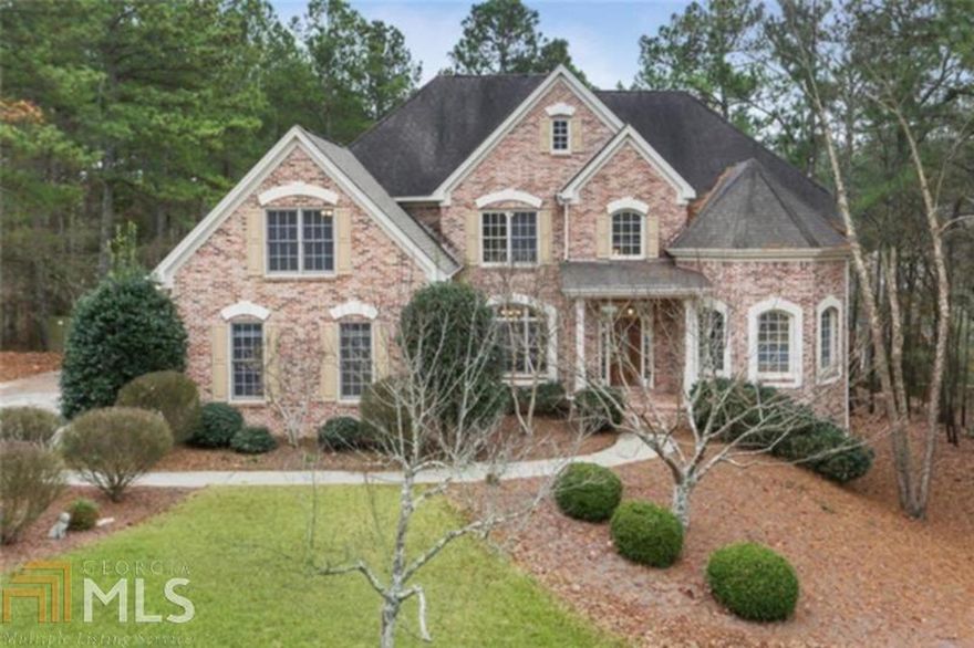 Stunning executive home with 3 car garage and fine architectural detailing. Beautiful custom molding and arched windows create a natural elegance throughout the home. 5 bedrooms, 4.5 baths, 3 sided brick nestled on private quiet cul-de-sac lot. Oversized master suite on main, spa-like bathroom features 3 large elliptical windows over whirlpool tub, his & her vanities and walk-in closet. Gourmet kitchen with new white cabinetry overlooks vaulted keeping room with fireplace and eat-in breakfast room making the perfect center for family gatherings. Upper level  offers 2 bedrooms with connecting bath and two additional ensuite bedrooms. Unfinished daylight walk-out terrace level for future growth. Large rear deck overlooks beautiful private backyard. Prime location with easy access to schools, shopping, US 41 and Lakes Allatoona and Acworth.