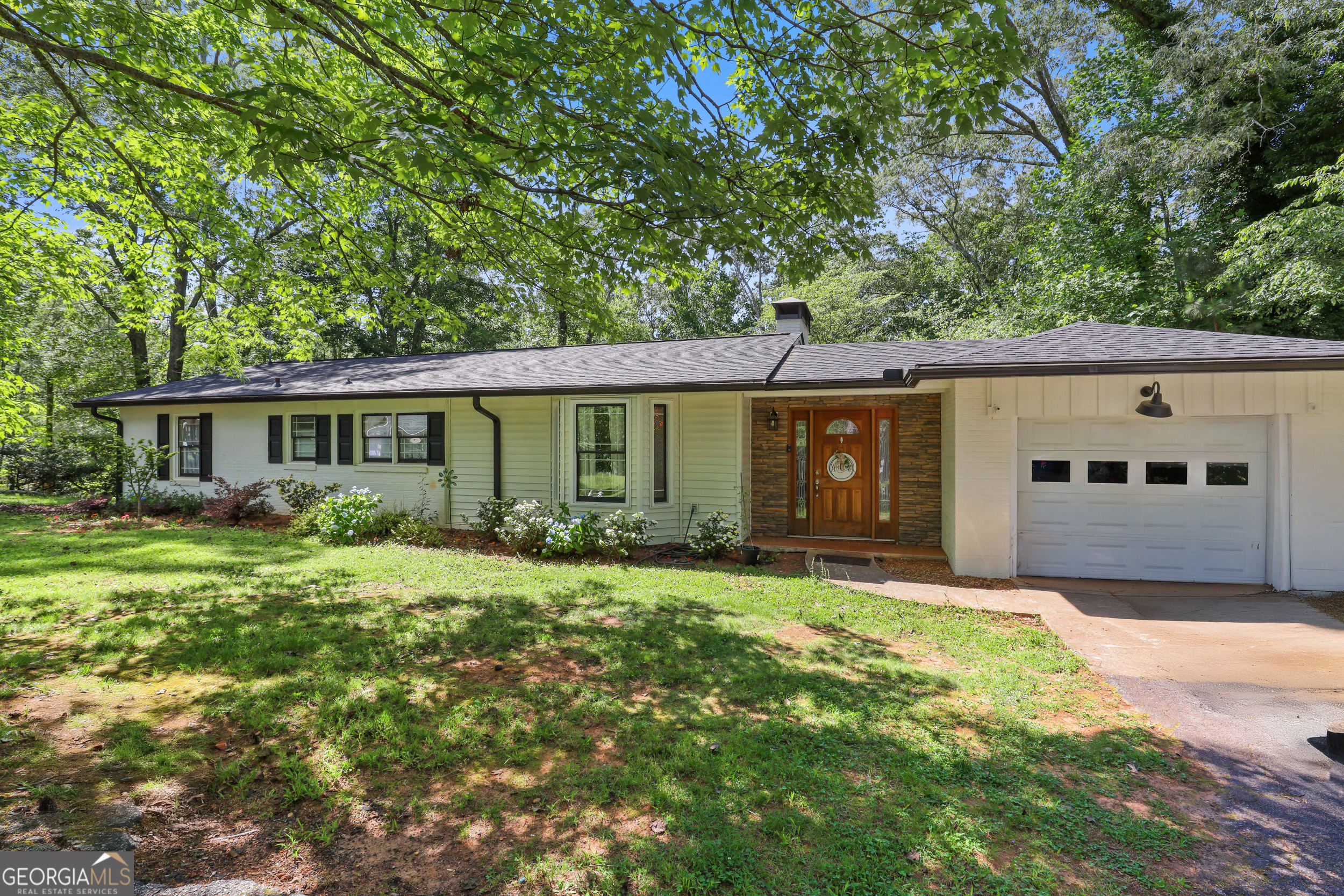 Charming In-Town Living in the Heart of Demorest! Welcome to 201 Georgia Street-a beautifully maintained home nestled on a spacious corner lot just steps from Piedmont University and downtown Demorest. This 3-bedroom, 2-bath home offers a perfect blend of historic charm and modern updates, including a bright, open floor plan, updated kitchen with stainless steel appliances, and hardwood floors throughout. Enjoy your mornings on the welcoming front porch and spend evenings in the backyard-ideal for entertaining, pets, or gardening. With fresh interior paint, updated bathrooms, and ample natural light, this move-in ready gem is perfect for first-time buyers, investors, or anyone looking to enjoy small-town living with city conveniences. Don't miss this rare opportunity-schedule your showing with the Zach Garvey Team today!