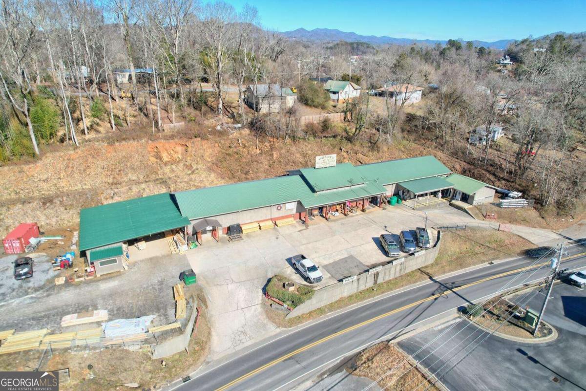 Embark on a lucrative business and real estate ownership opportunity with this commercial icon located in the city of Murphy for over 45 years operating as Wilson's Building Supply. The property comprises 3.51 acres improved with a 9,600-sf main building consisting of retail space, showroom, 2nd level office space, restrooms, 10 customer parking spaces, 40' x 44' metal frame open shed as well as a 25' x 22' framed receiving deck with canopy. Within this space, discover the convenience of well-appointed offices, a customer counter, public restrooms, and ample storage facilities for seamless operations. The main building is complemented by three detached metal-framed open sheds, providing versatile spaces for lumbar storage, and building materials. Security is paramount with a fenced and gated perimeter as well as a lumber yard guard booth, ensuring a protected environment for the extensive assets included in the sale. The comprehensive inventory of vehicles, including pickups, delivery trucks, forklifts and more, further enhances the turnkey nature of this offering. Don't miss the chance to own an established family business with years of financial history and strength within a well-appointed space, in an excellent location with assets designed for continued success for years to come. Confidentiality Agreement and Proof of Funds are required before any financial documentation will be made available for review.