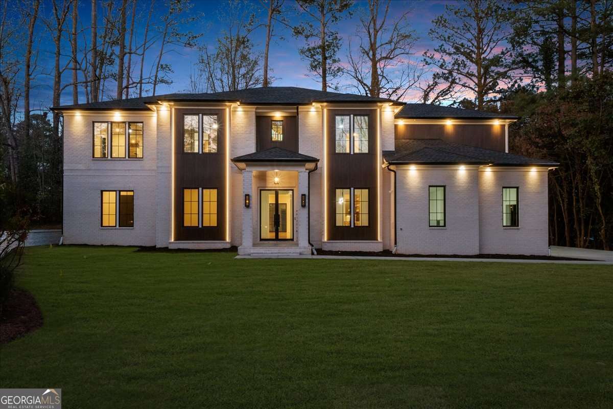 Welcome to 942 Fairfield Drive in the prestigious Indian Hills community of East Cobb! This stunning new construction home boasts four sides of brick, complemented by elegant gas lights and a modern porch with epoxy flooring. Enjoy an expansive 3-car garage with a 220V electric outlet for EV charging, plus a tankless water heater for ultimate efficiency. Inside, the home is equipped with recessed lighting, wired for surround sound speakers throughout, and beautiful wooden and tile flooring. The chefCOs kitchen features a custom island with pendant lights, quartz countertops, a Forno 60-inch refrigerator, dual gas/electric stove with 8 burners, smart microwave, and a convenient pot filler. For added convenience, the kitchen island also includes a motorized pop-up outlet with a built-in wireless charger, making it easy to power devices without clutter! The adjoining prep kitchen includes a refrigerator, dishwasher, and sink with under-cabinet lighting, while the full bar offers an ice maker, wine cooler, and wooden countertops. The homeCOs elegant design extends to the dining and breakfast areas, with LED lighting and rope light crown molding. The foyer greets you with a floating custom lighted box and a striking pendant chandelier, complemented by glass railings and accent wall. The family room features a cozy fireplace, plenty of natural light, more rope lighting, and custom built-ins. The luxurious Primary Suite on the main level includes a custom accent wall, a fireplace, rope lights, and exquisite paneling. Included in the Primary Bath are LED mirrors, a free-standing tub, heated floors, and a smart heated toilet for ultimate relaxation! With exceptional details and high-end finishes throughout, 942 Fairfield Drive is a true masterpiece designed for modern living!