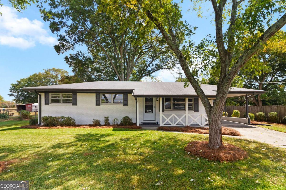 Stunningly renovated 3 bed/1 bath featuring brand new Luxury Vinyl Plank flooring, new interior and exterior paint, new lighting and plumbing fixtures everywhere, new kitchen cabinets, new granite countertops in kitchen and bathrooms, and new stainless-steel appliances. Home offers beautiful curb appeal with a 1-car carport and covered front porch. Enter into the living room offering large windows to allow in lots of natural lighting. Kitchen offers new cabinets, new granite, plenty of cabinets and countertops space, new stainless steel appliances, and eat-in dining area. Family room off the kitchen offers a fireplace and access to the backyard patio. Three good sized bedrooms with great closet space and bathroom with tub/shower combo. Out back the patio overlooks the large fenced in backyard and storage shed.