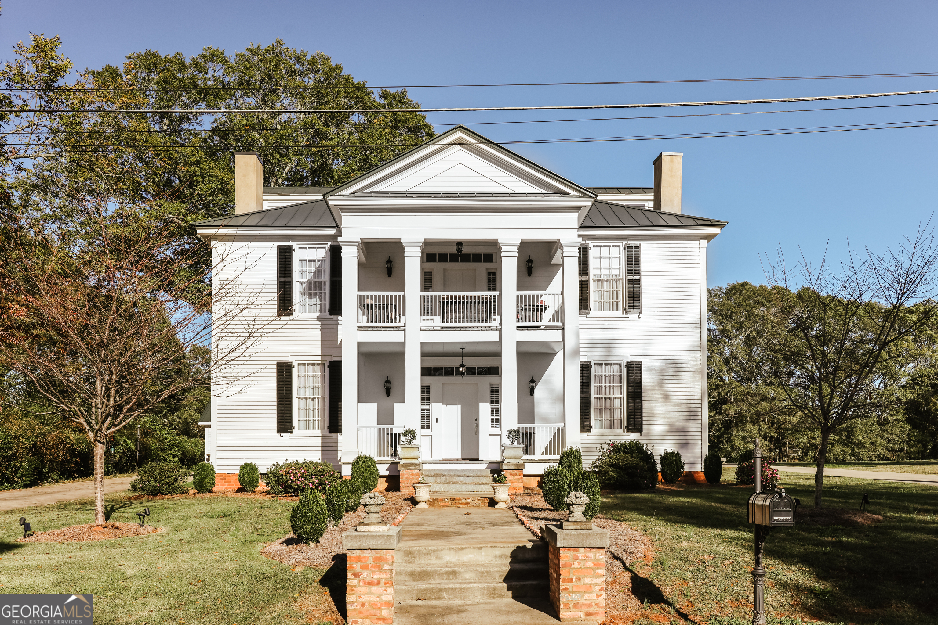 Welcome to the Ozborn house.  This house has been painstakingly brought back to its former glory but with all the modern convenience. Built pre-civil this home exudes sense of grandeur and refined architectural elegance.  Towering columns support a grand, symmetrical portico. Large crystal-clear windows allowing abundant natural light to flood the interior while offering views of the beautiful lot. Inside the home offers opulence and innovation. Original heart of pine floors throughout the entire home. To the left is a "double parlor" with two fireplaces. To the right is a formal living room and master suite with marble bathroom. The Kitchen has been beautifully redone while retaining elements of the original home as accents.  Upstairs there is an en-suite bedroom, that could be used as a master, and two additional bedrooms and a bath. The unfinished third level offers versatile space for finishing or for storage.  In addition, the original "kitchen" is on the back grounds and would make a perfect guest house or office. It dates from the 1890's and was connected to the main house by a porch before the house was moved 50' to the left in 2017. The flat backyard offers a perfect space for a pool. Such a unique opportunity to own a piece of history that has such loving memories attached to it. Please call to make an appointment today. Agent is an agent in Georgia